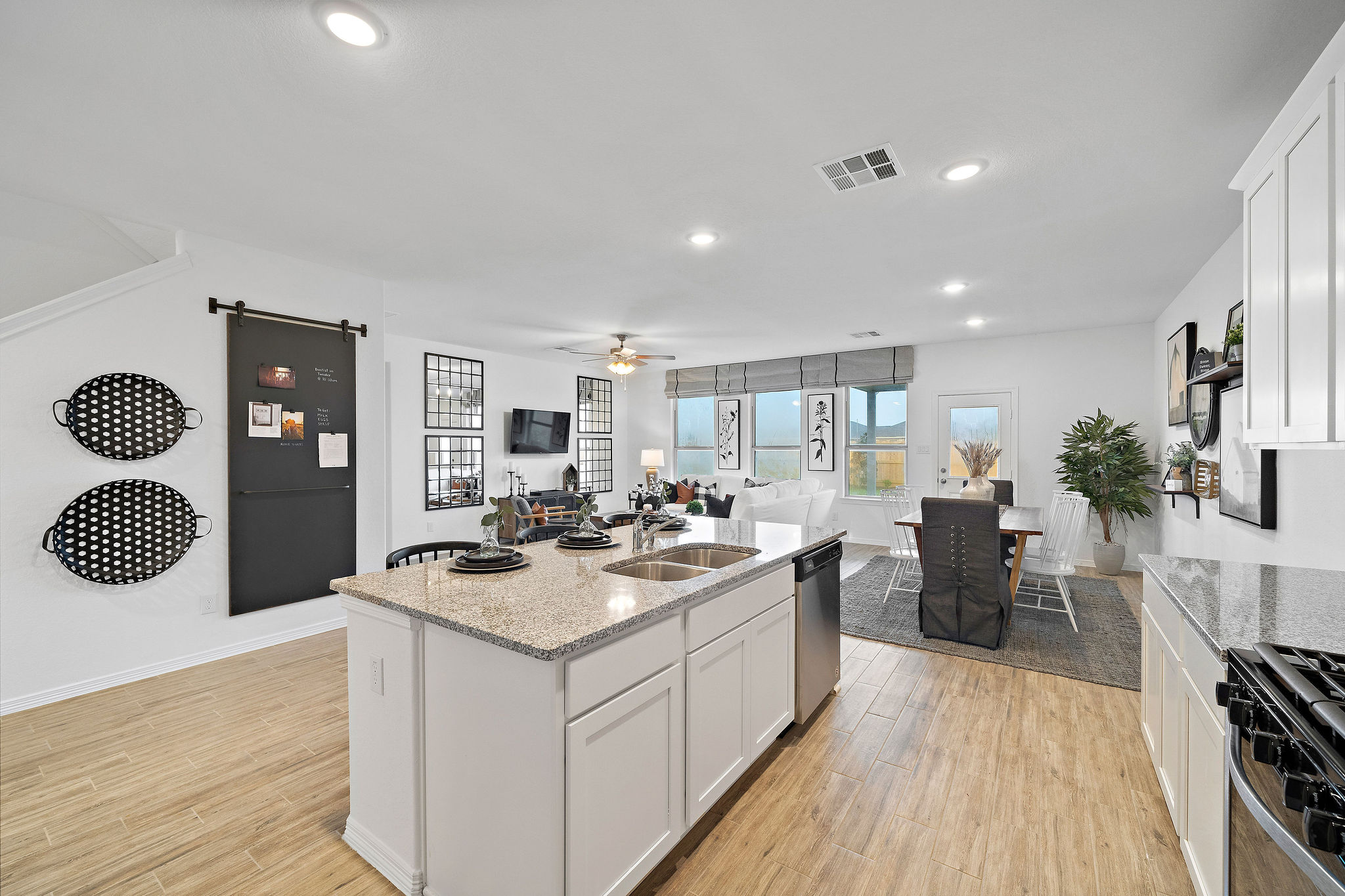 A kitchen with white cabinets.
