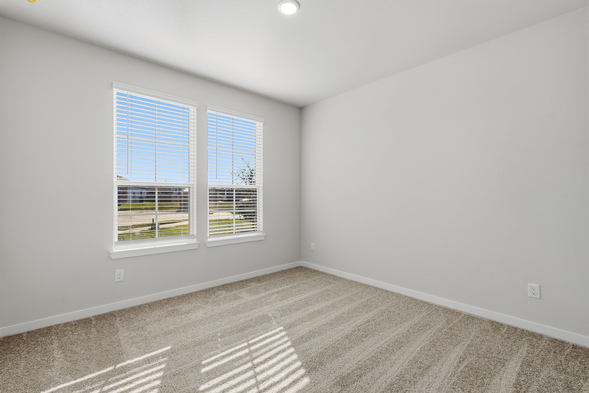 A room with a window and a carpet.