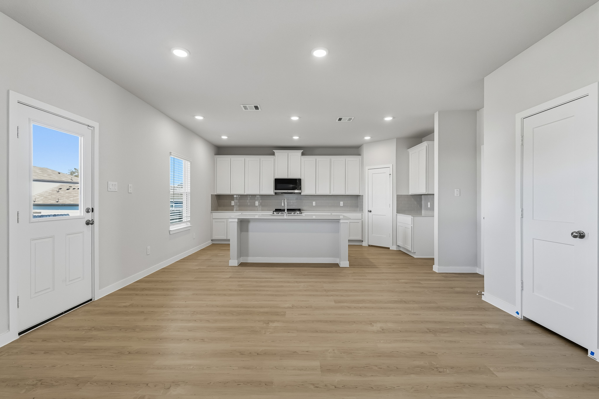 A large kitchen with white cabinets.