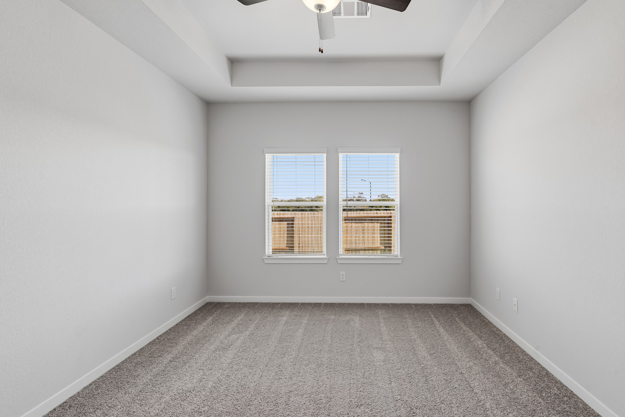 A room with a window and a carpet.