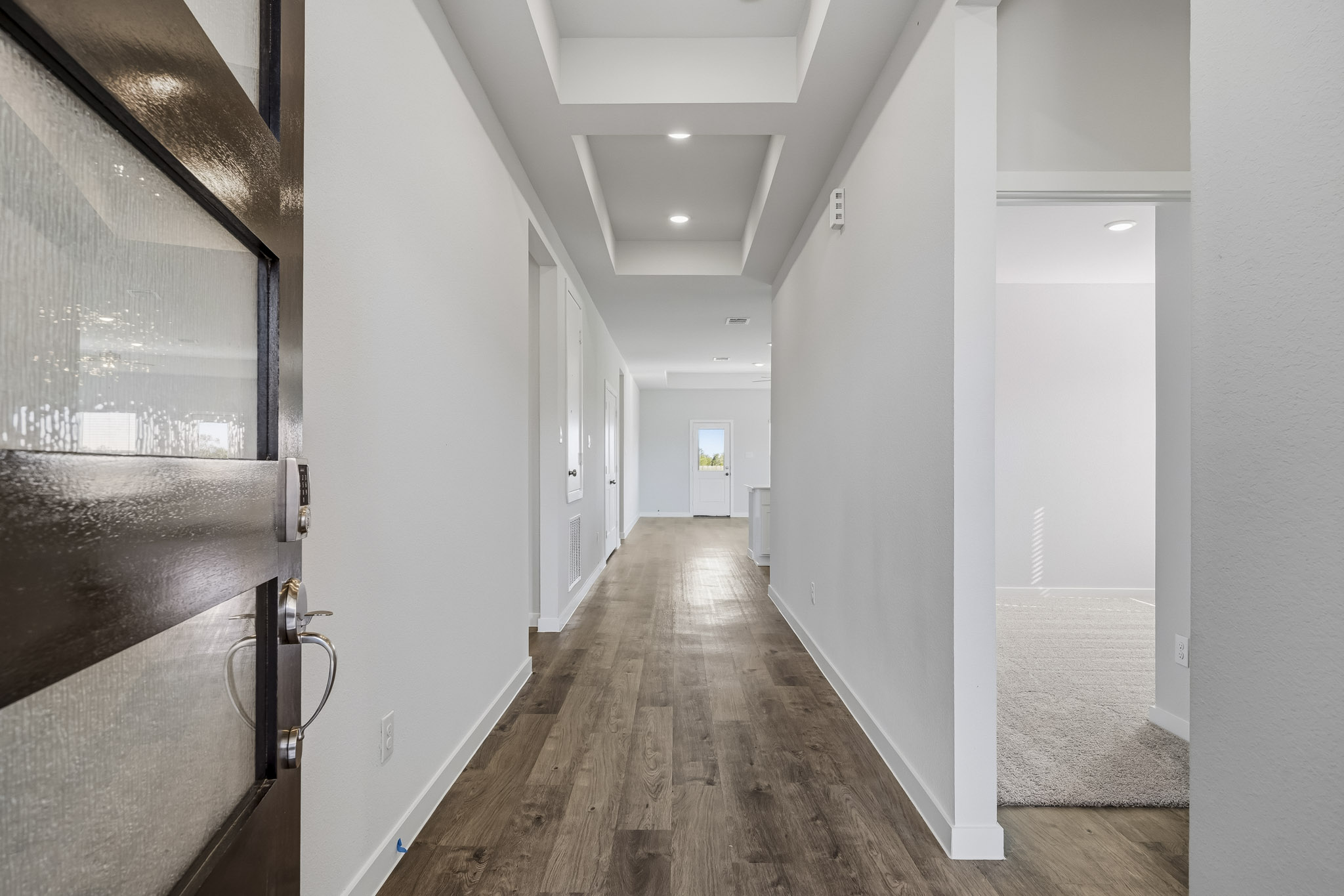 A hallway with white walls.