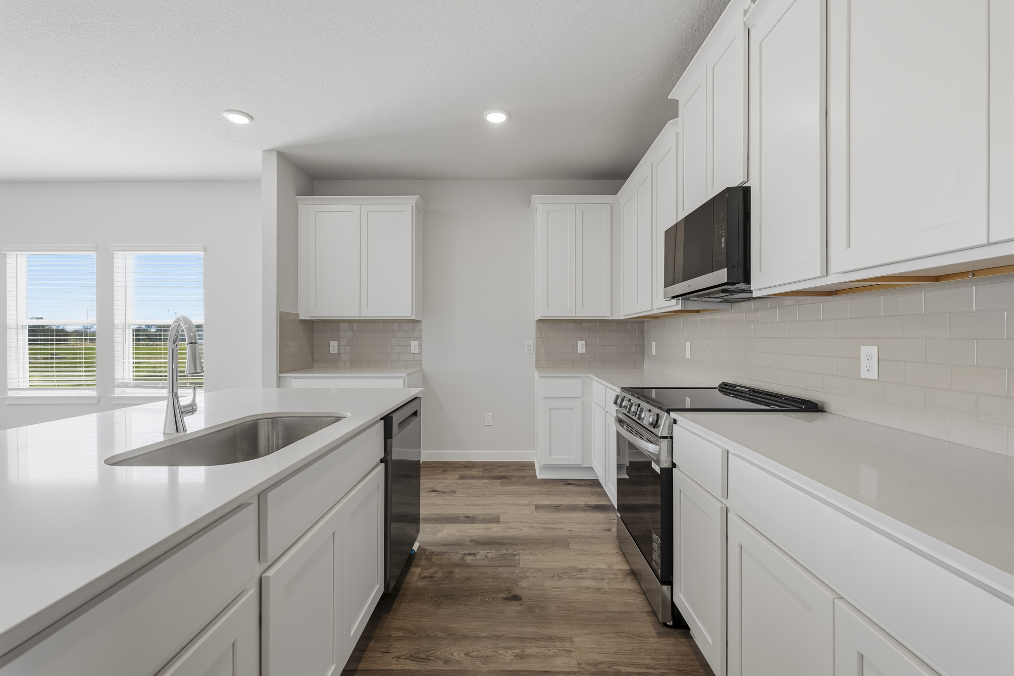A kitchen with white cabinets.