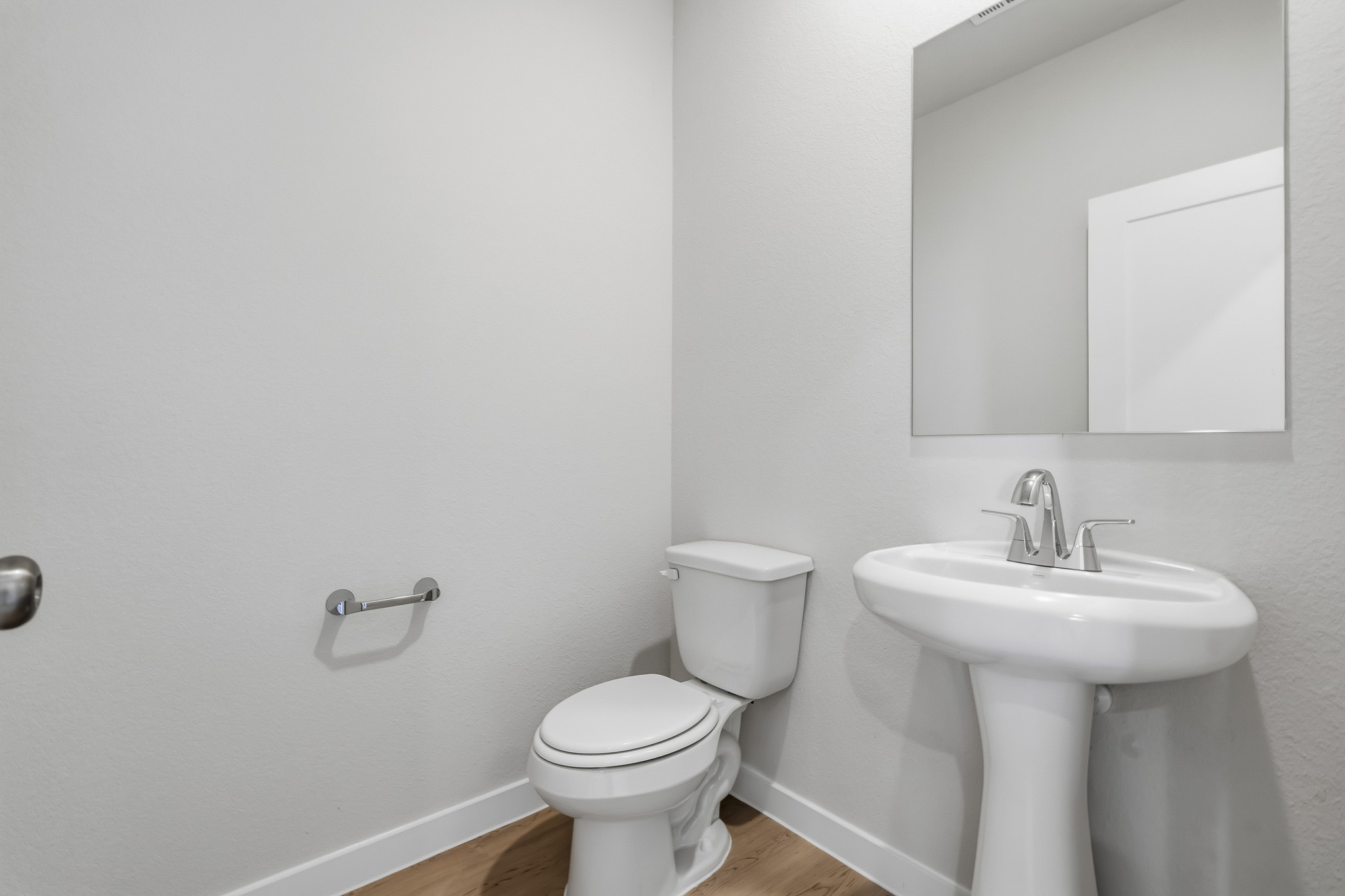 A bathroom with a toilet and sink.