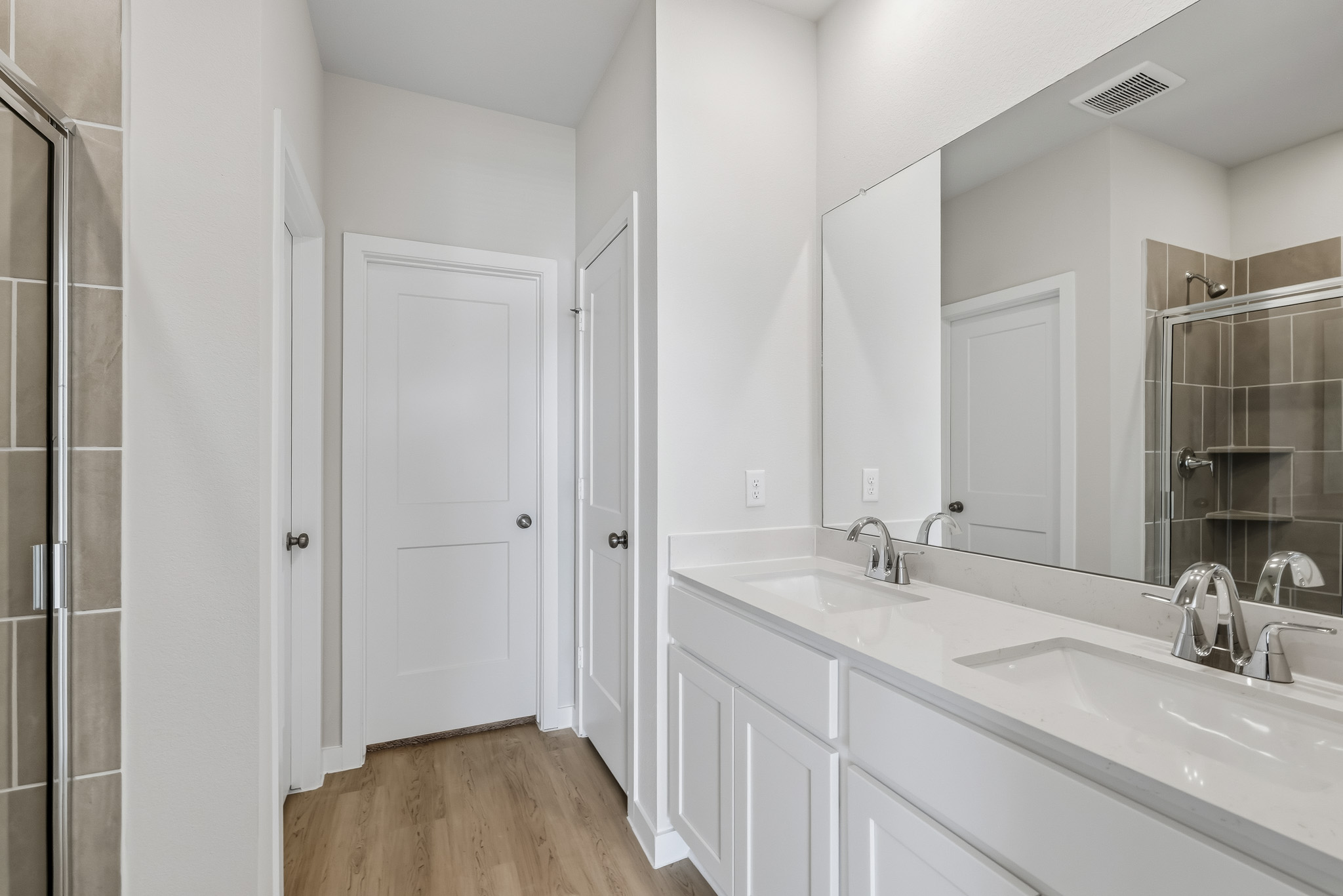A bathroom with a large mirror.