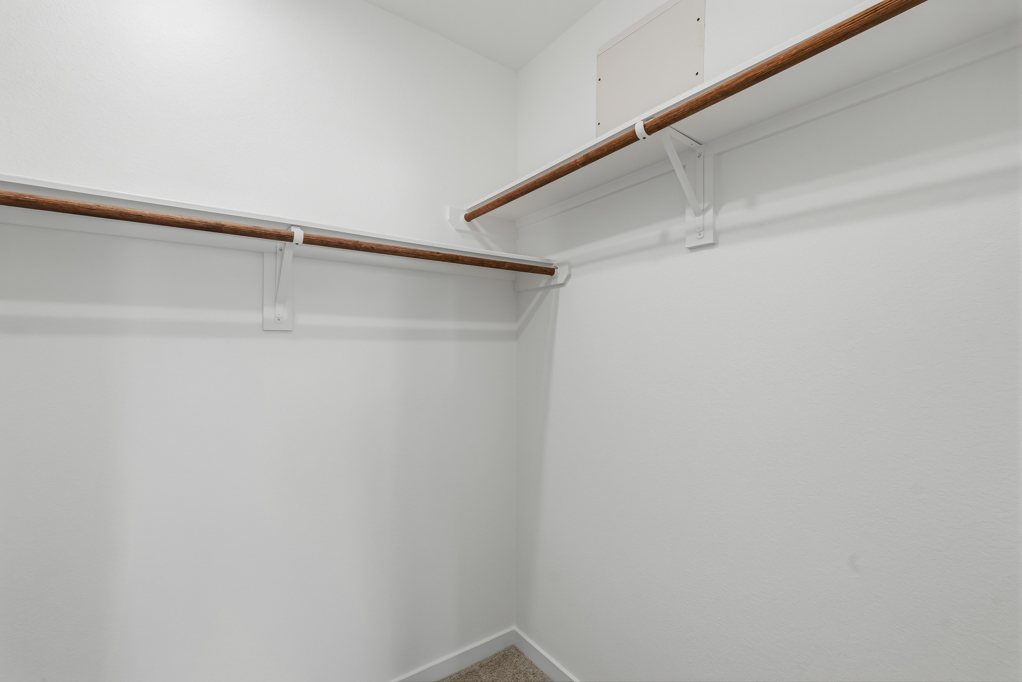 A white wall with a wooden railing.
