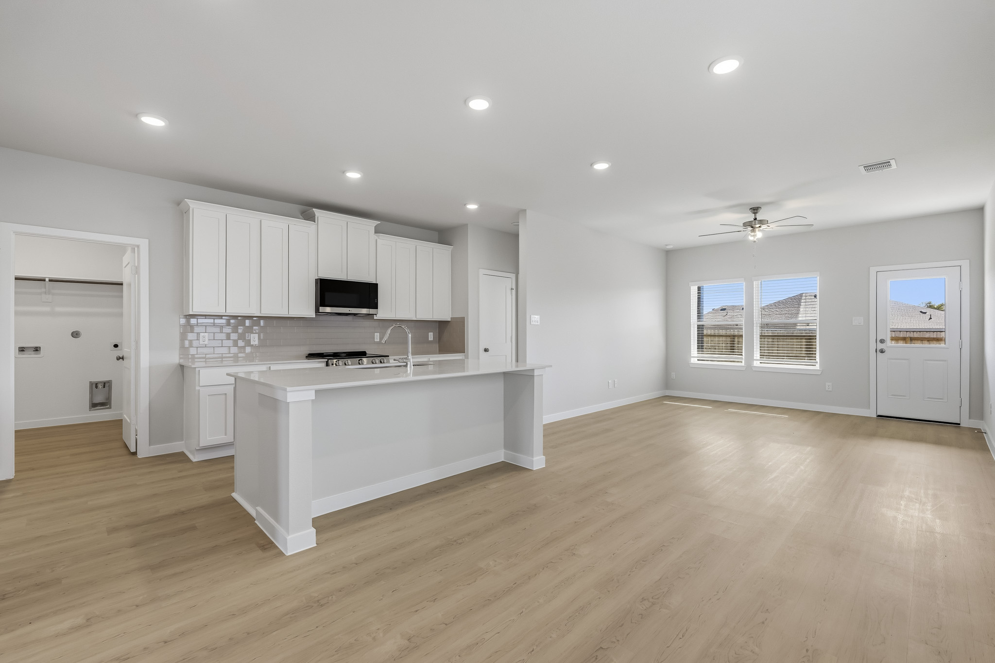 A kitchen with white cabinets.