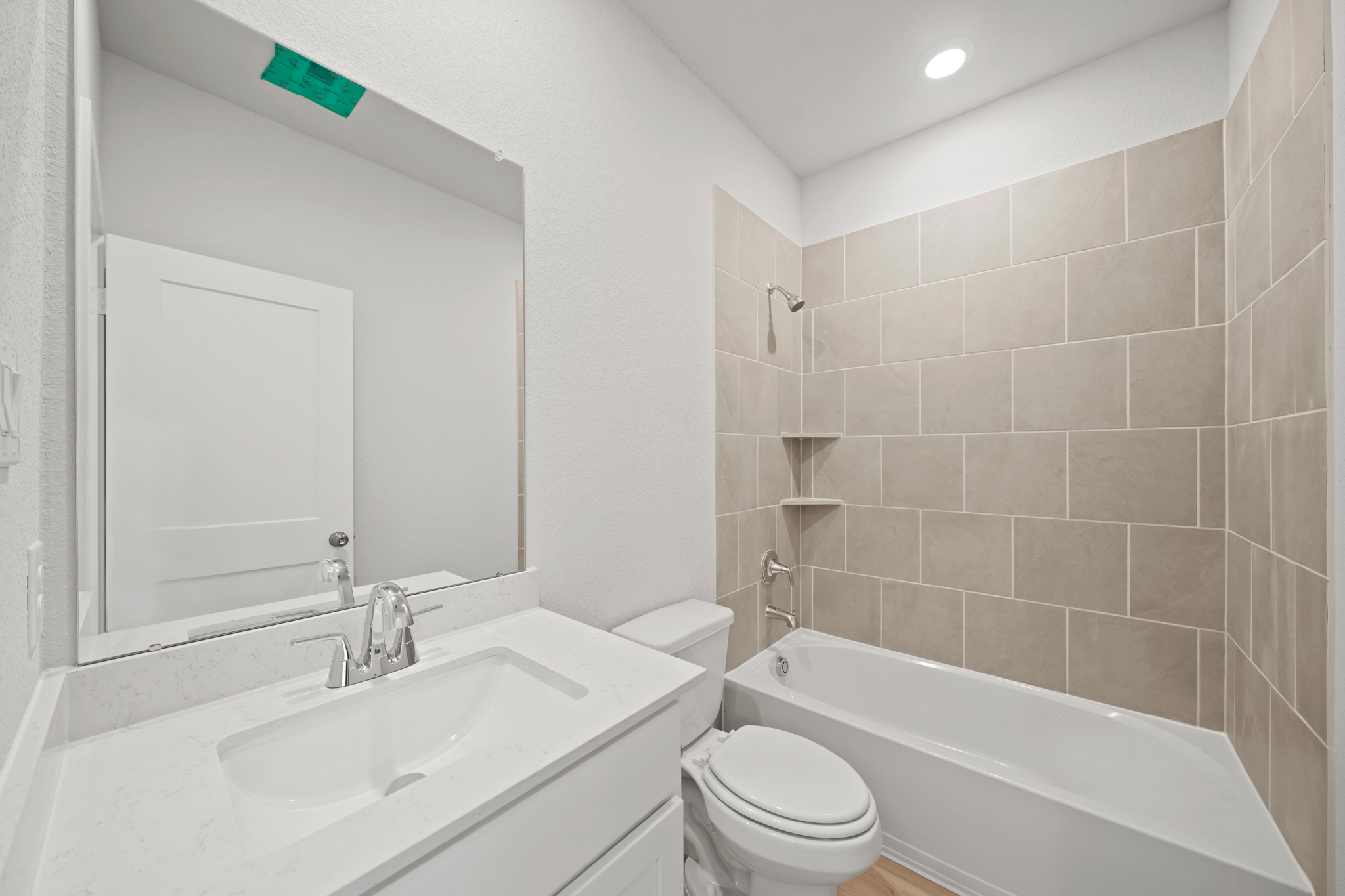 A bathroom with a sink toilet and bathtub.