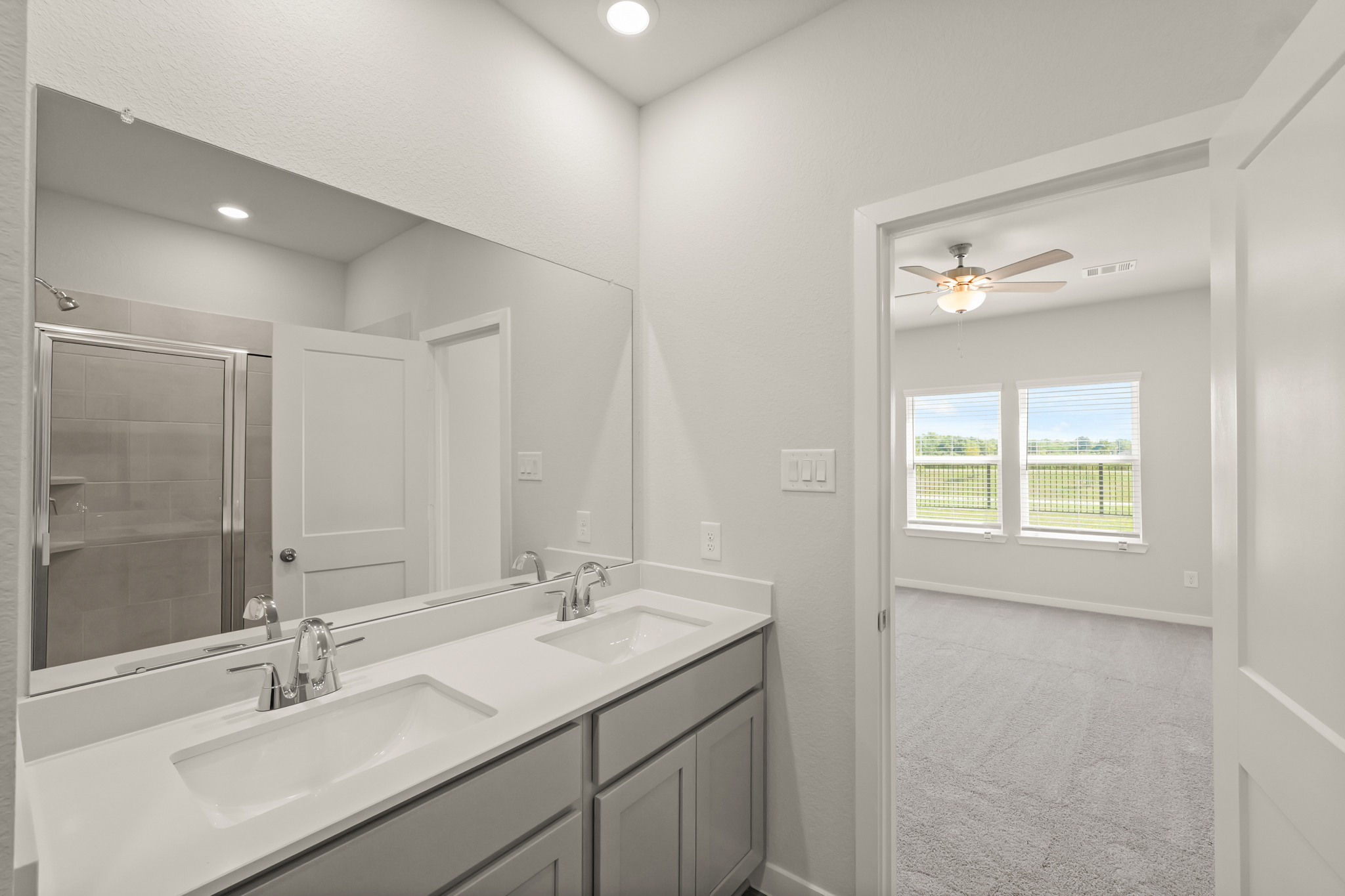 A bathroom with a large mirror.