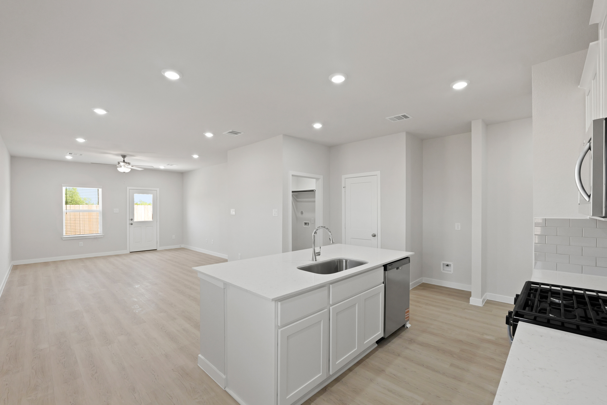 A large kitchen with white cabinets.