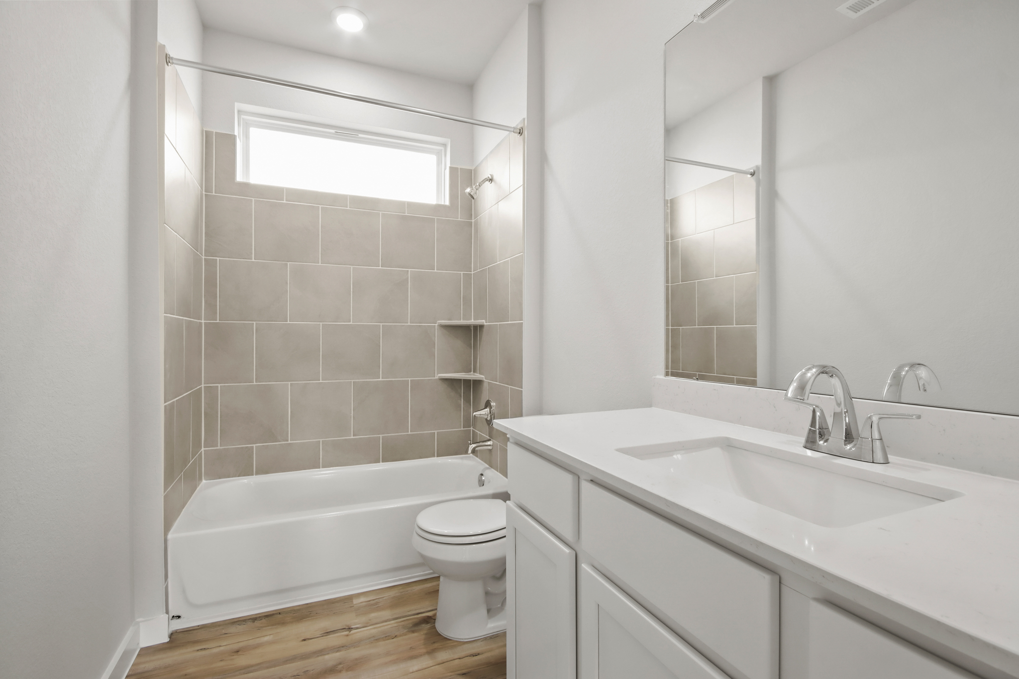 A bathroom with a tub sink and toilet.