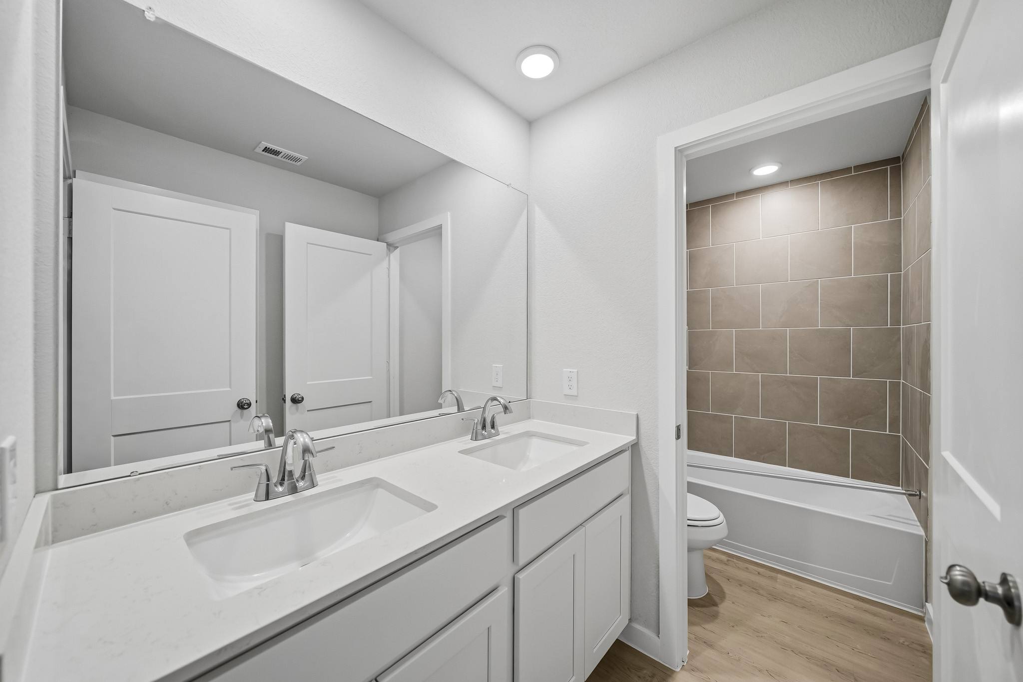 A bathroom with a tub sink and toilet.