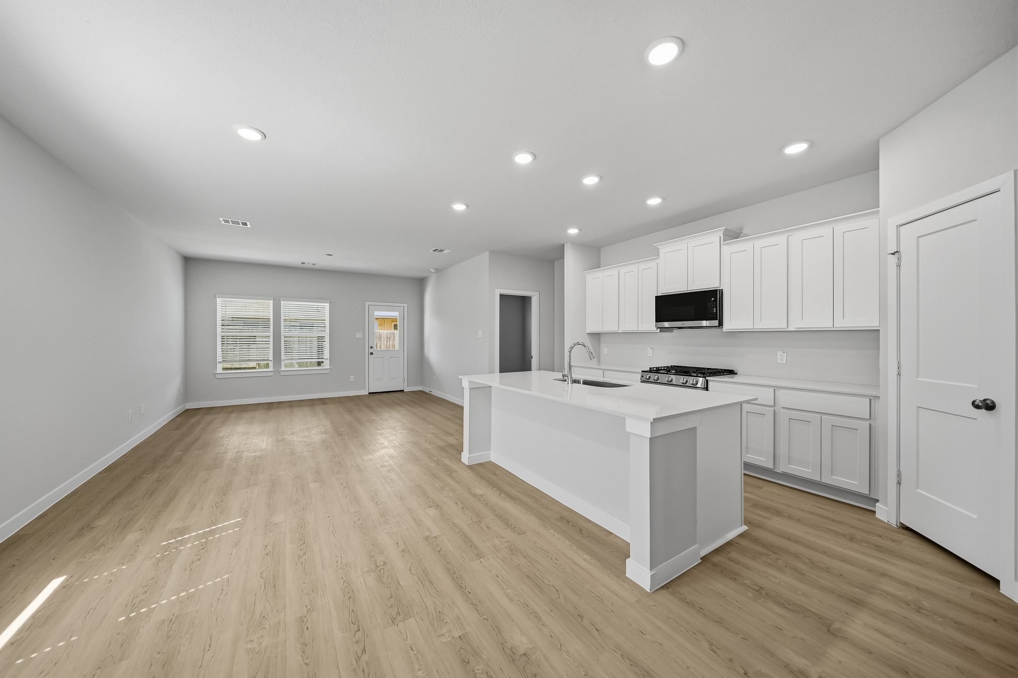 A kitchen with white cabinets.