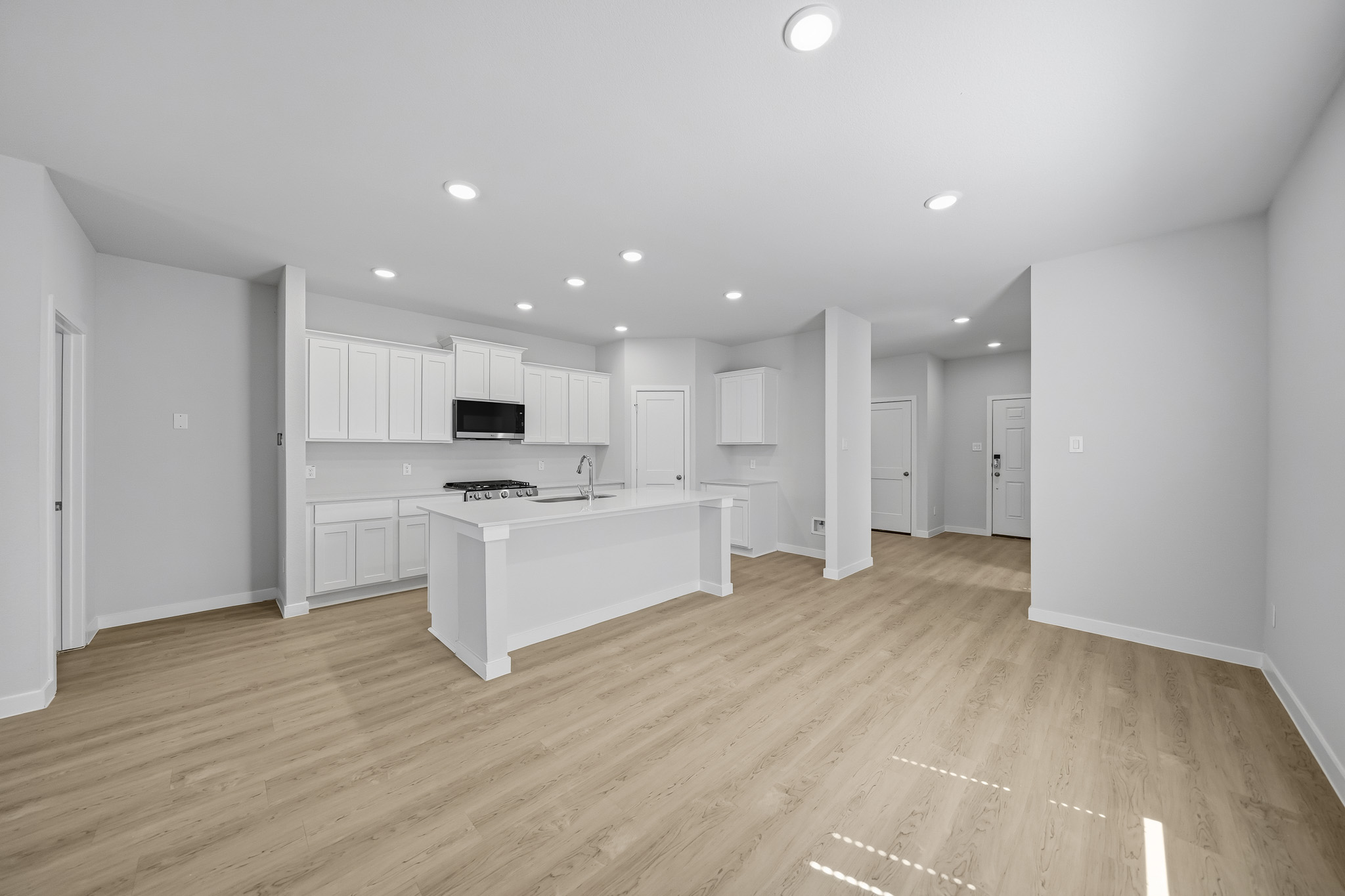 A large white kitchen with white cabinets.