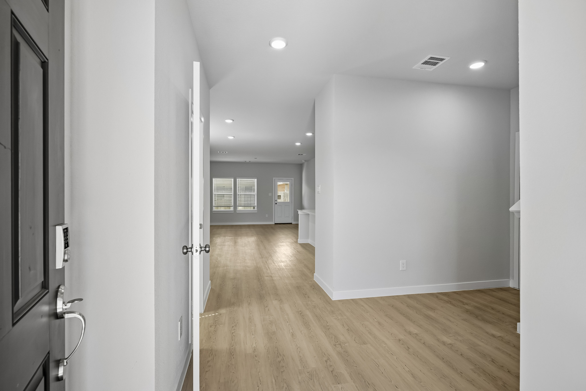 A room with a wood floor and white walls.