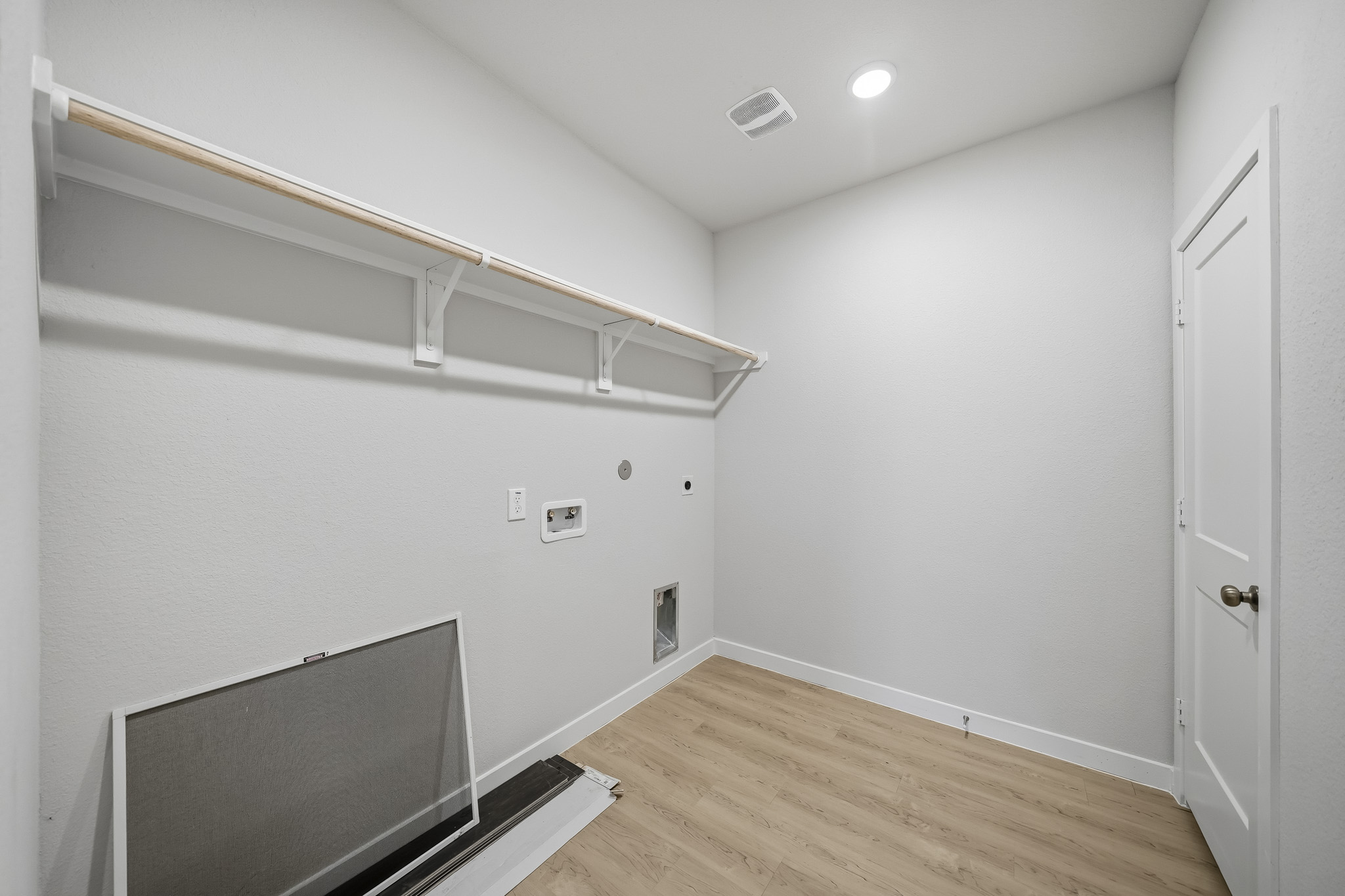 A room with a tv and a white wall.
