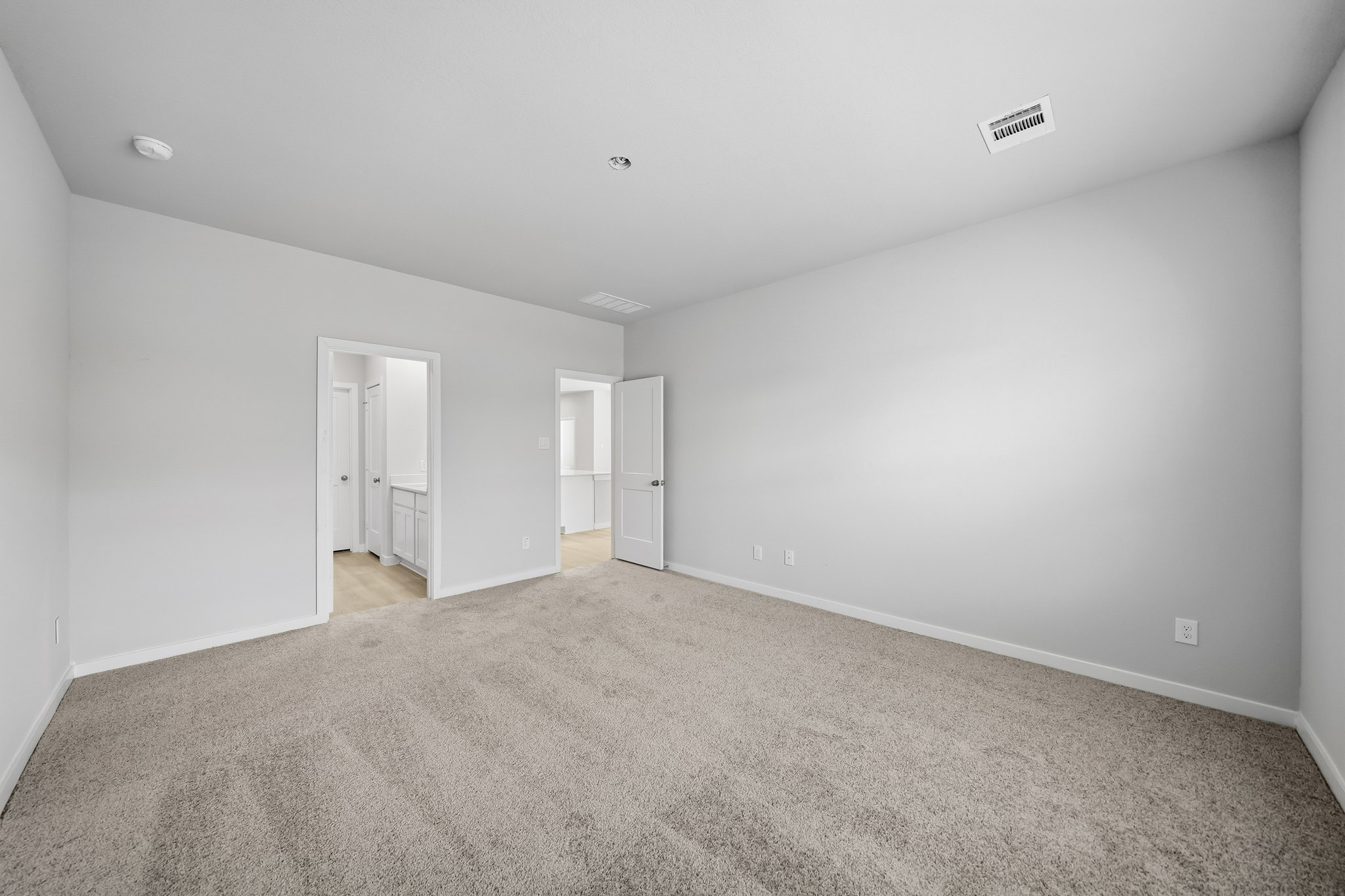 A long hallway with white walls.
