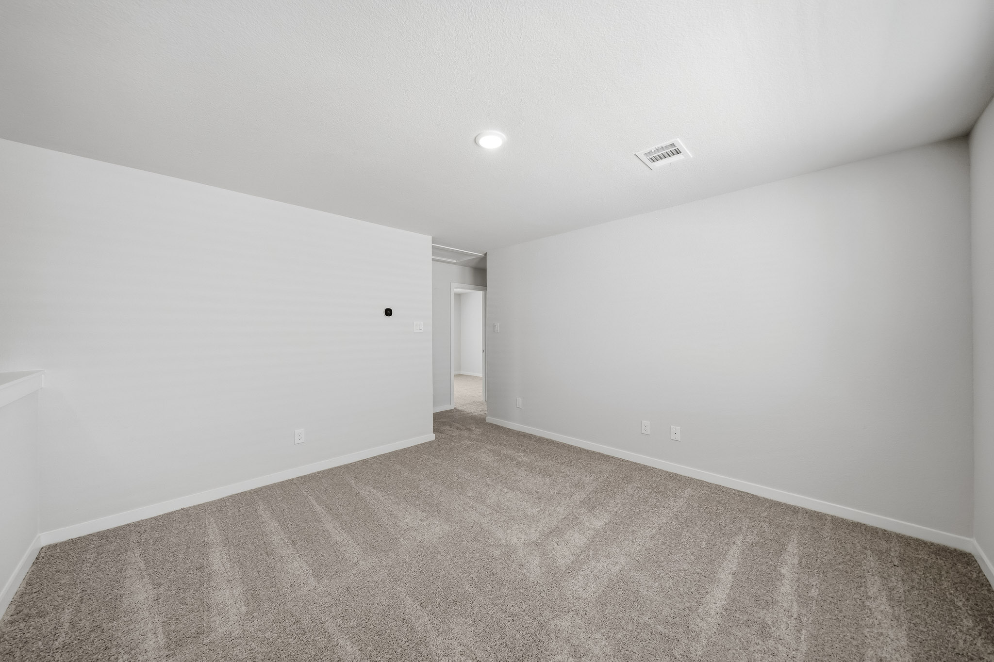A hallway with white walls.