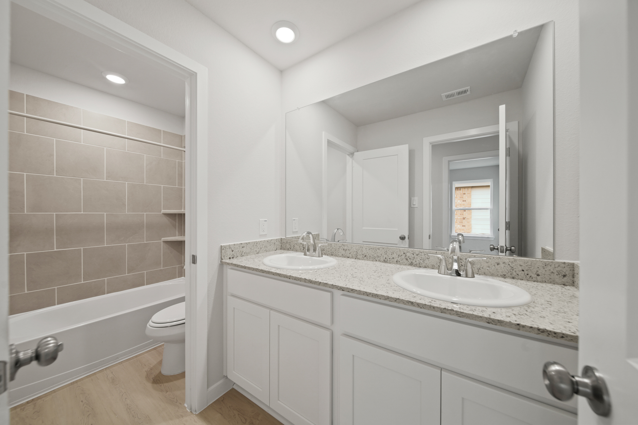 A bathroom with a large mirror.