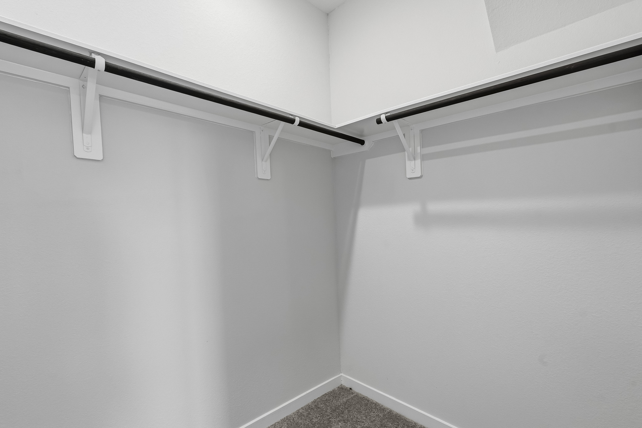 A white wall with a metal railing.
