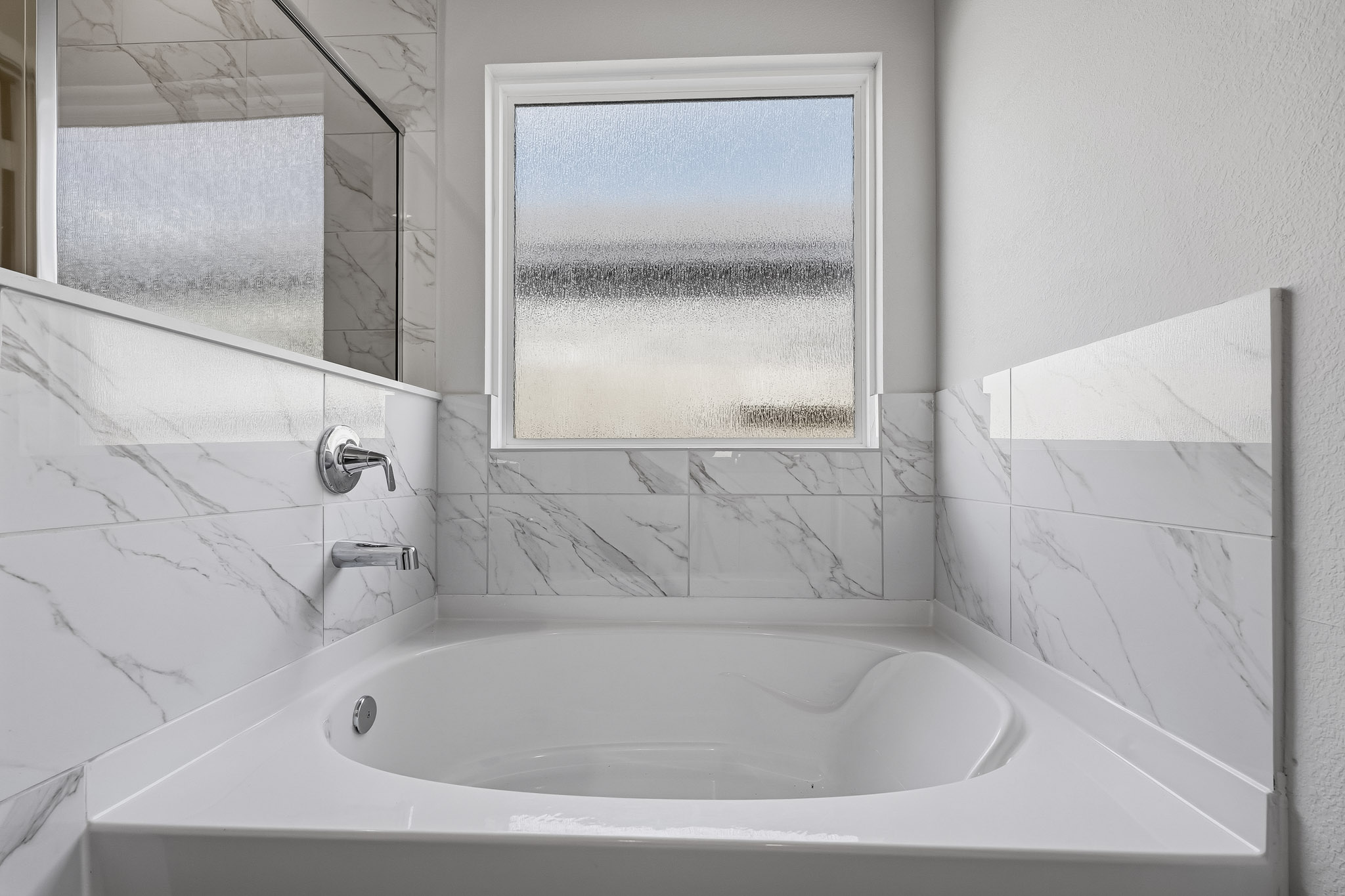 A bathtub with a window.