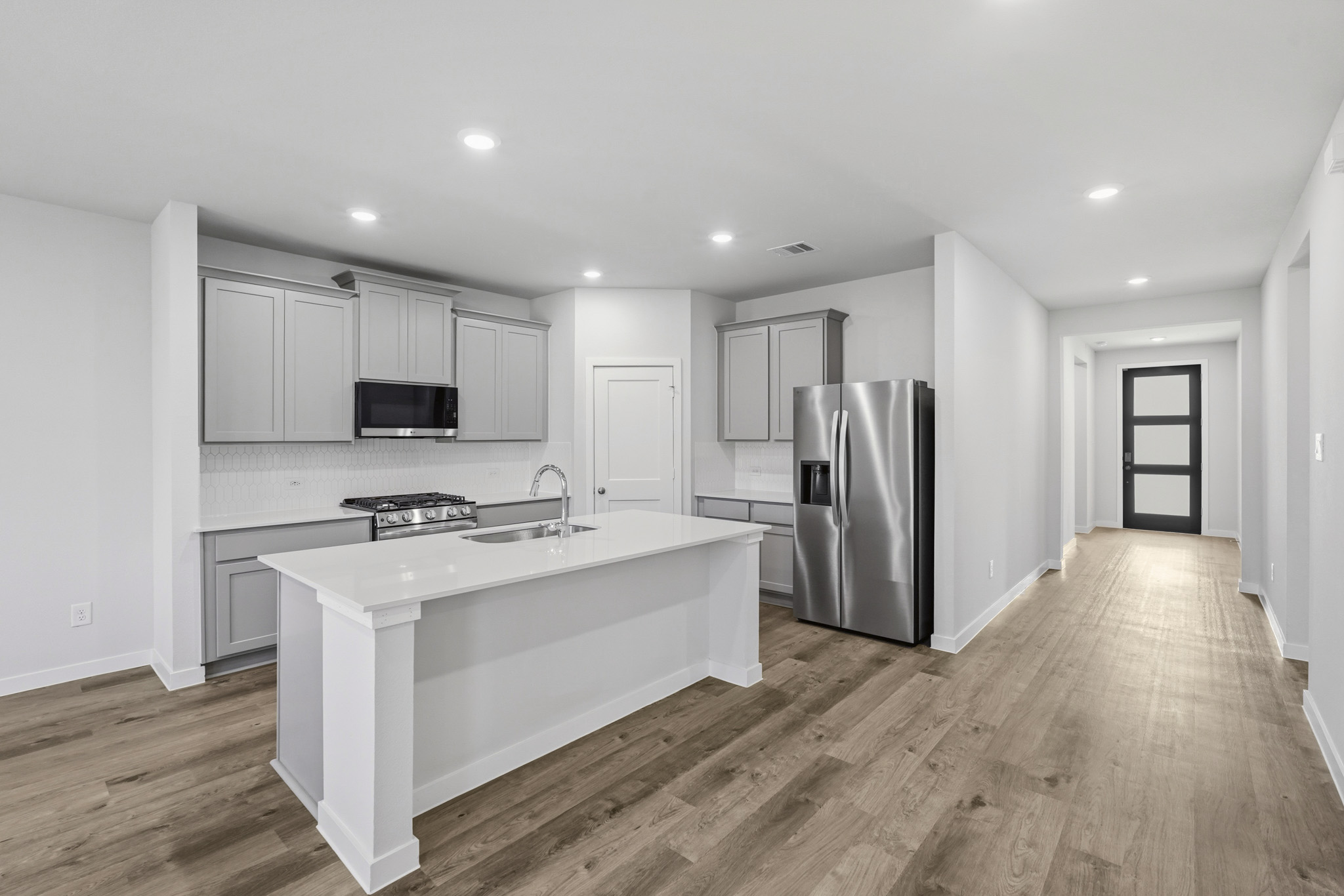 A kitchen with white cabinets.