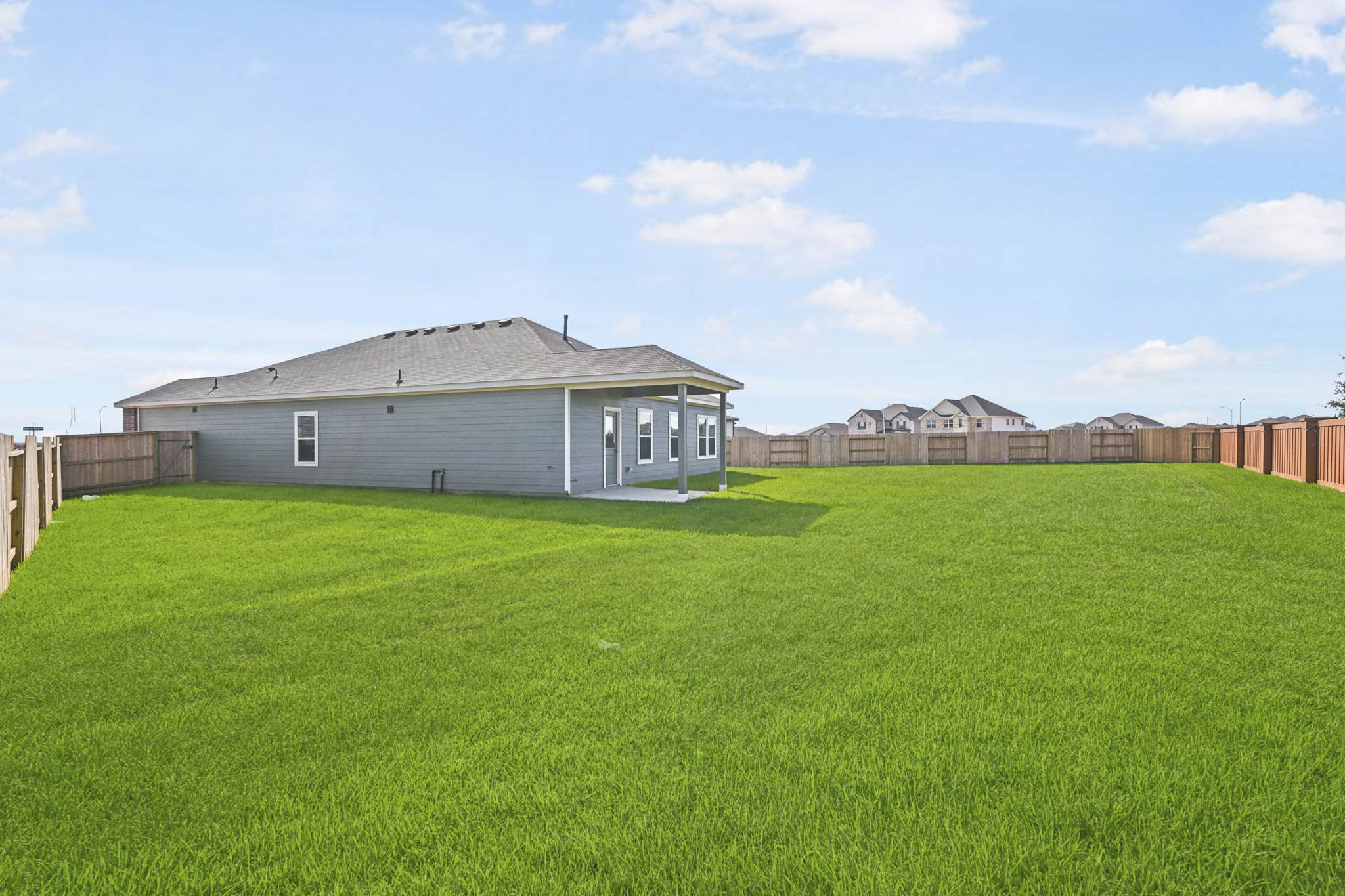 A house in a grassy field.
