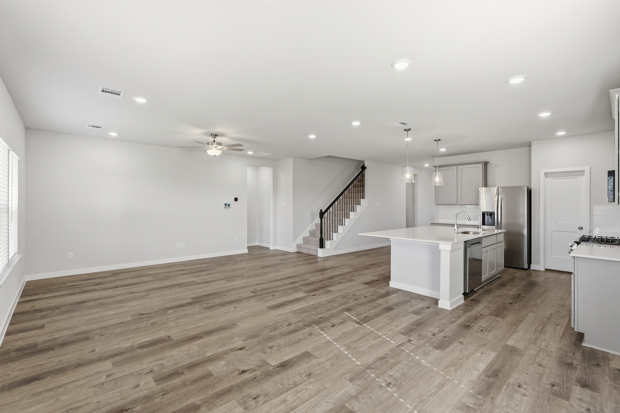 A large kitchen with wood floors.
