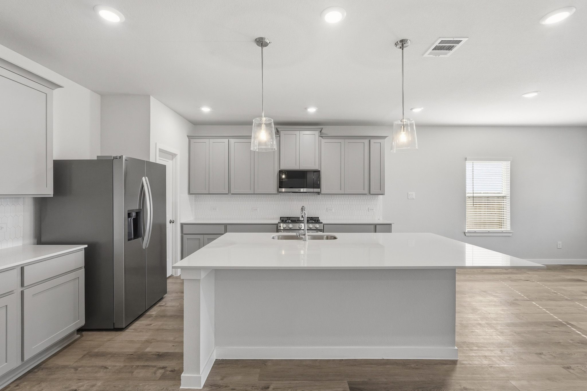 A kitchen with white cabinets.