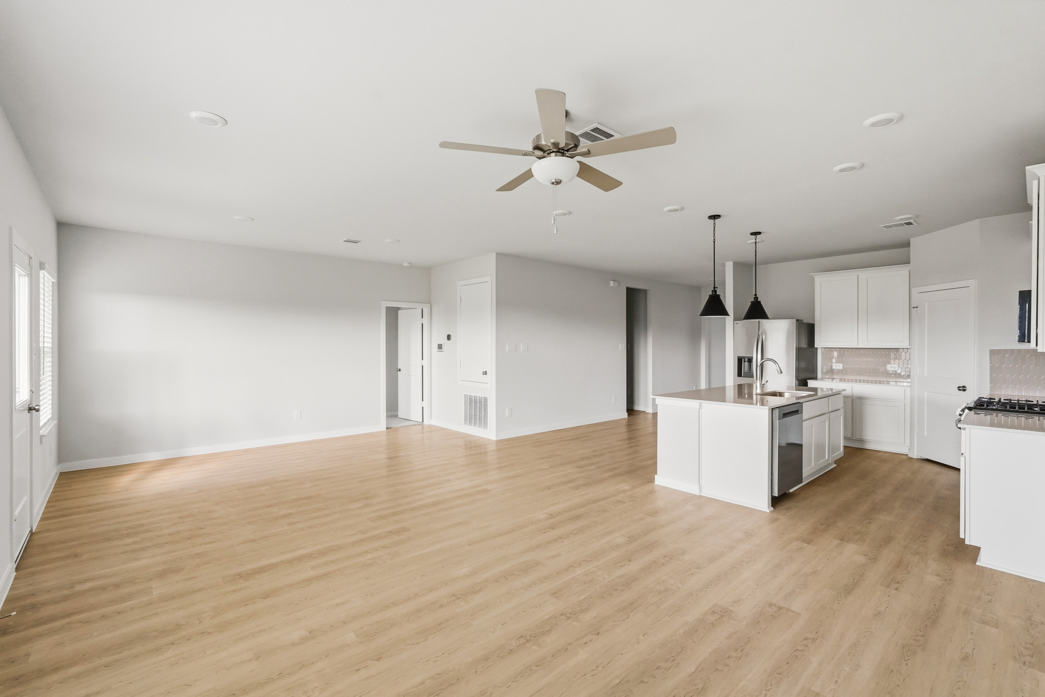 A large kitchen with white cabinets.