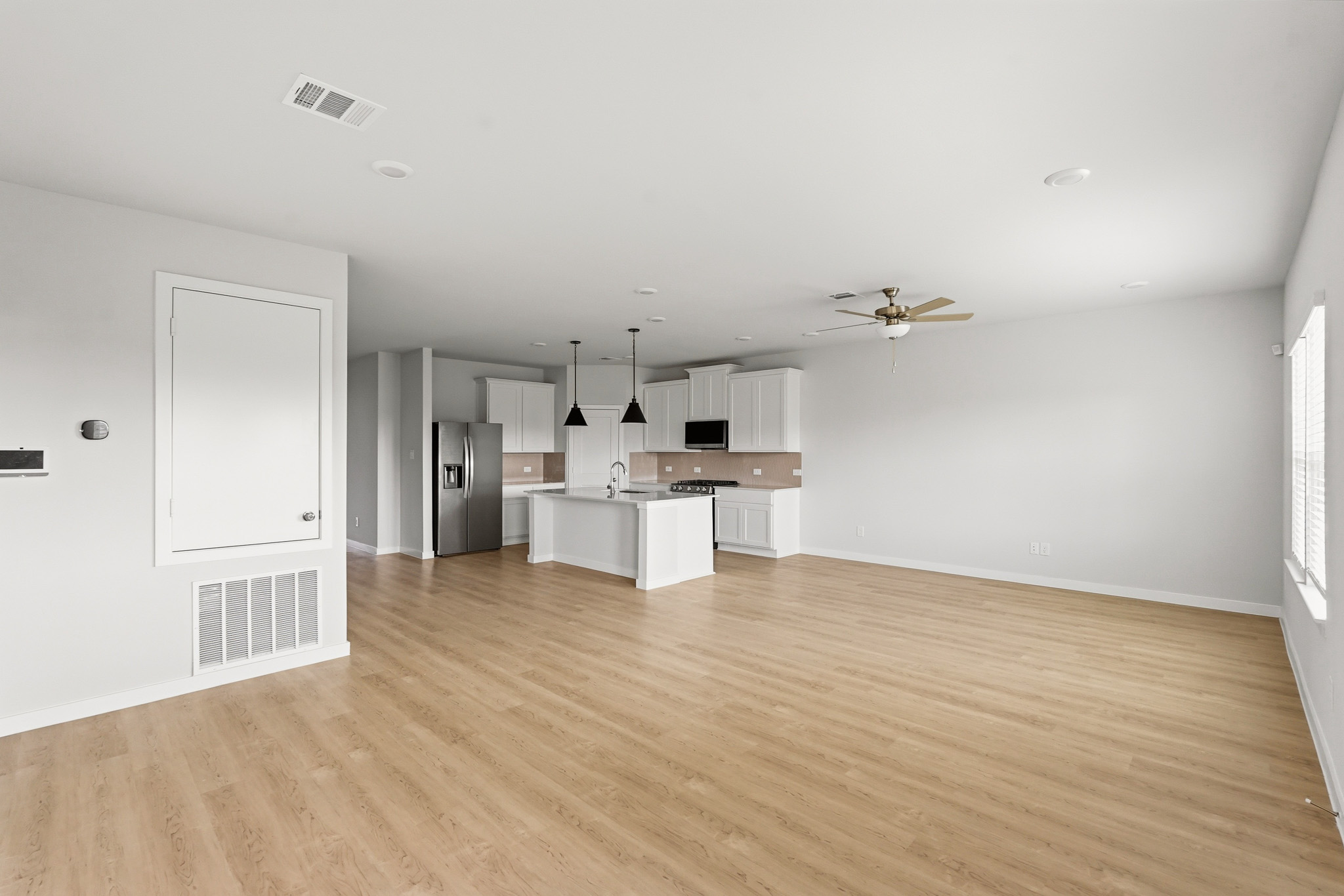 A kitchen with white cabinets.