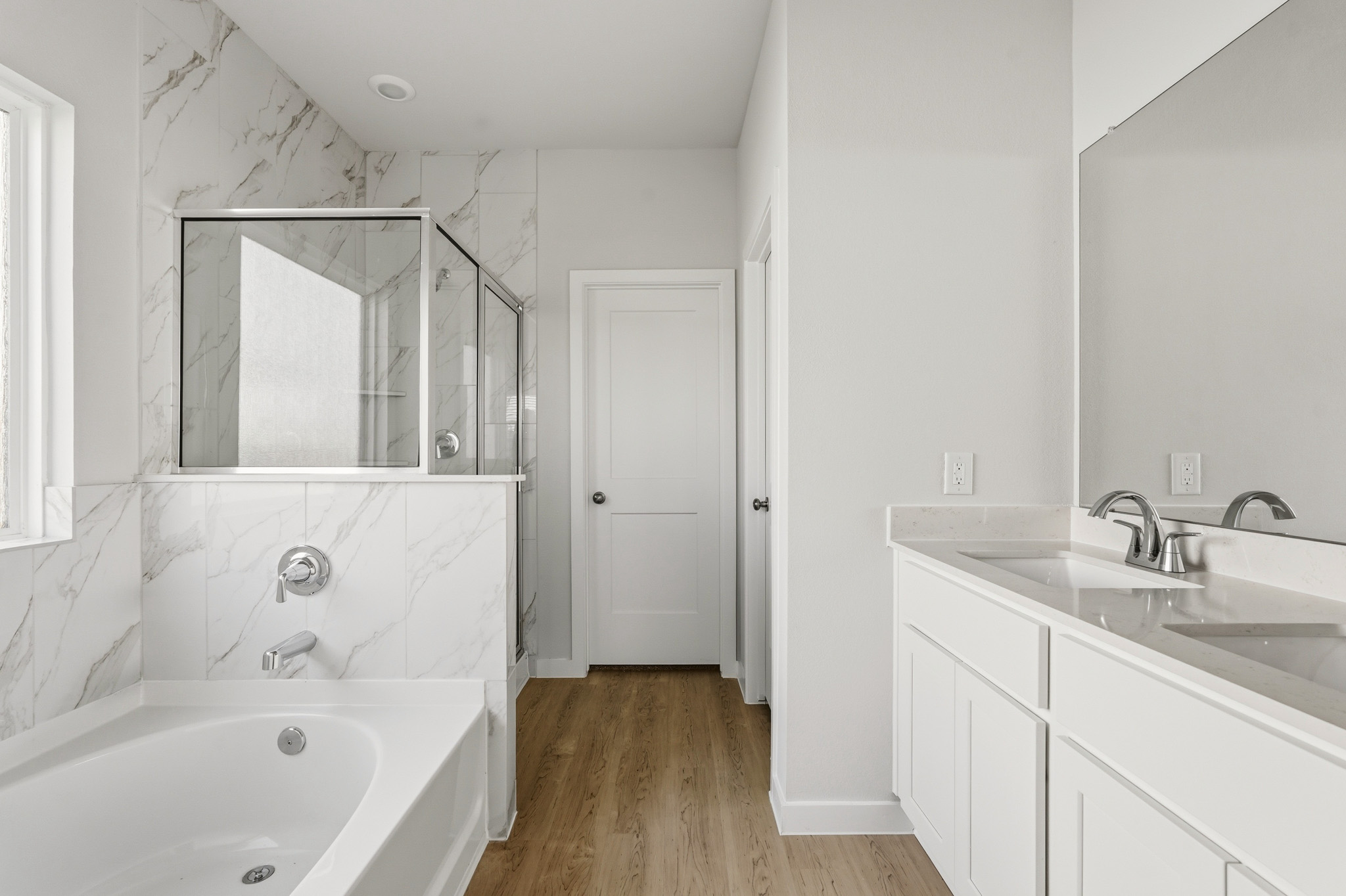 A bathroom with white cabinets.