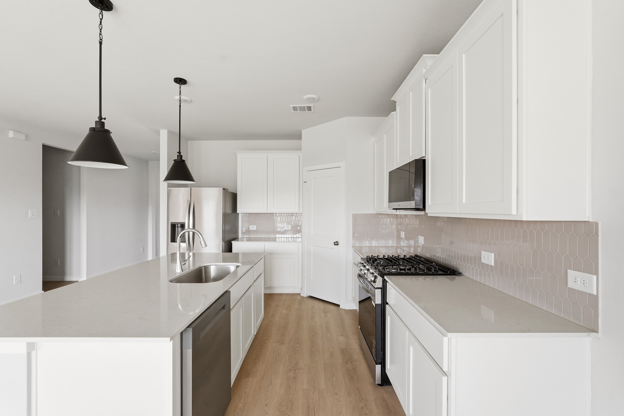 A kitchen with white cabinets.