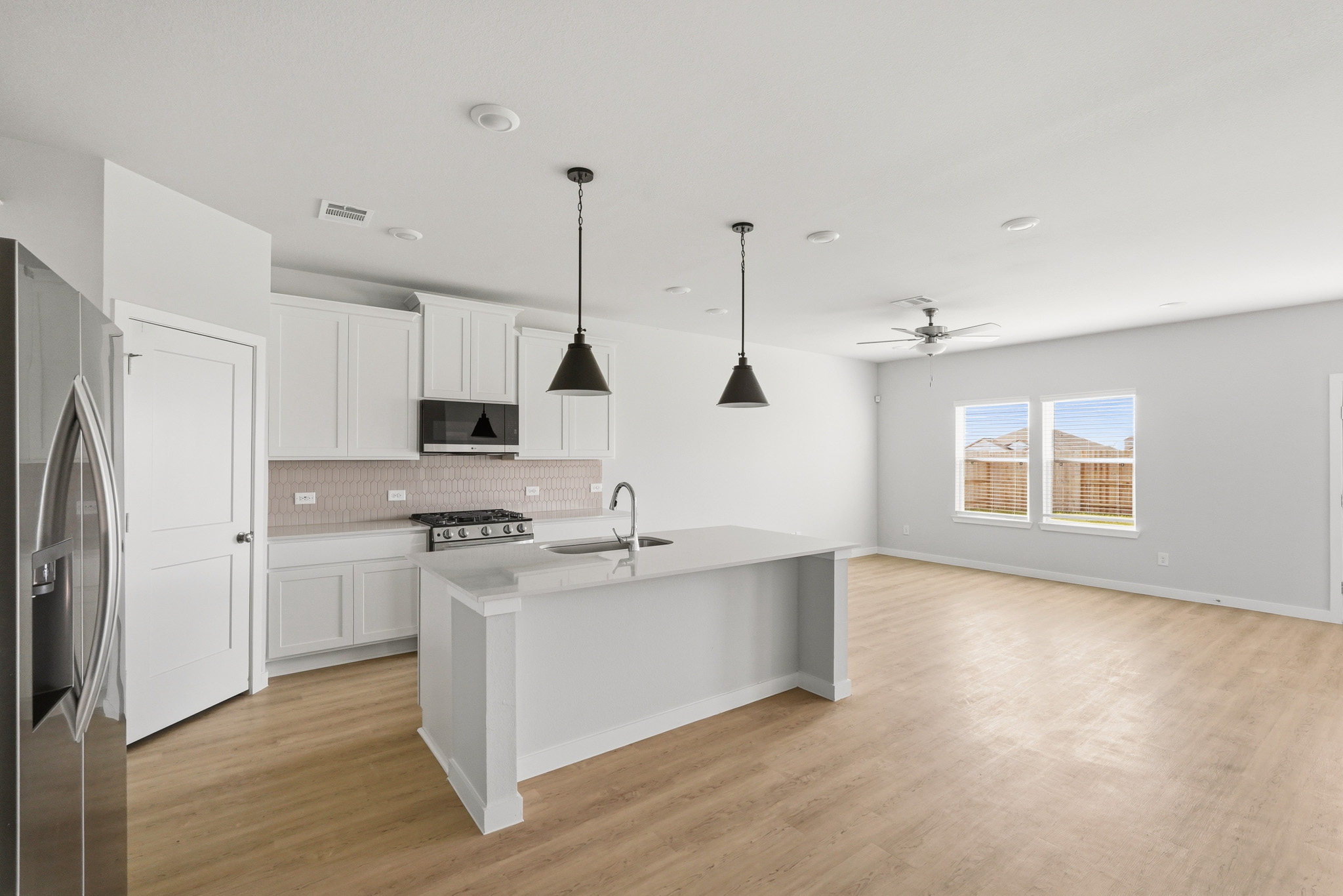 A kitchen with white cabinets.