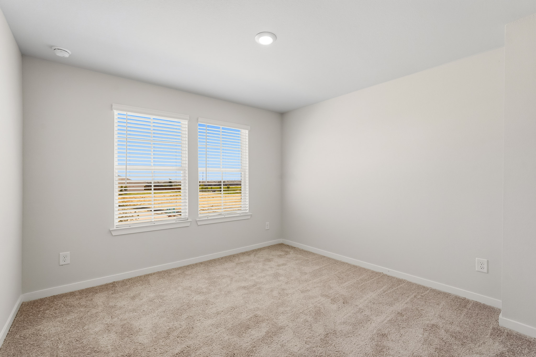 A room with a window and a carpet.