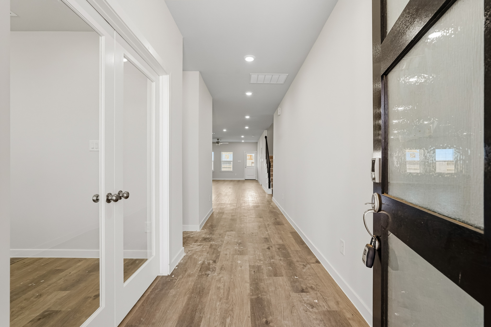A hallway with white doors.