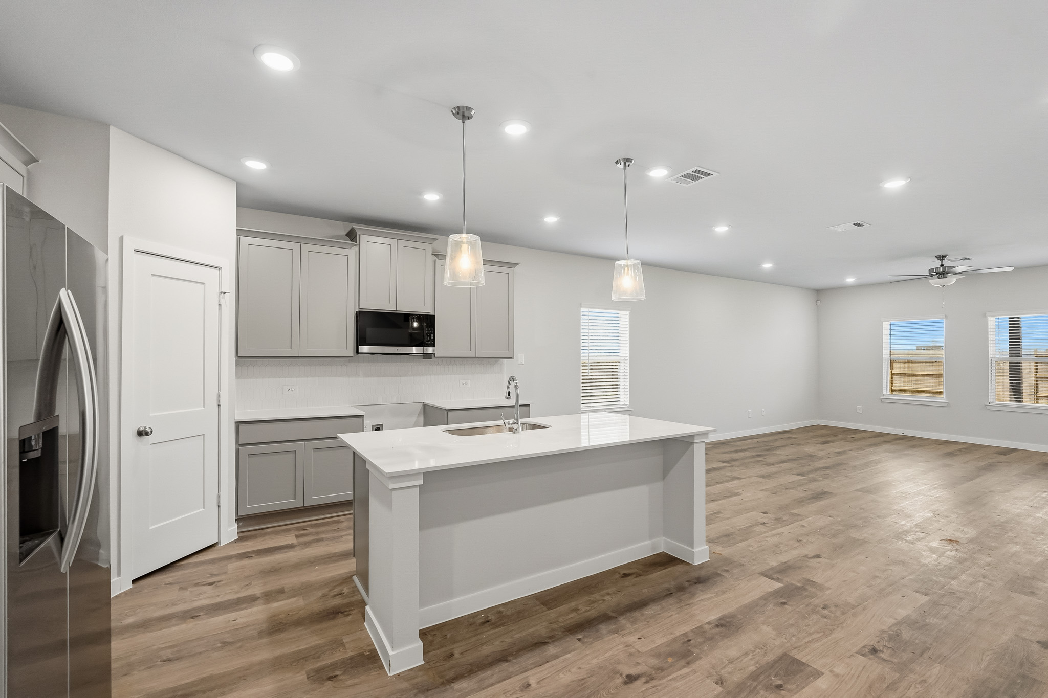 A kitchen with white cabinets.