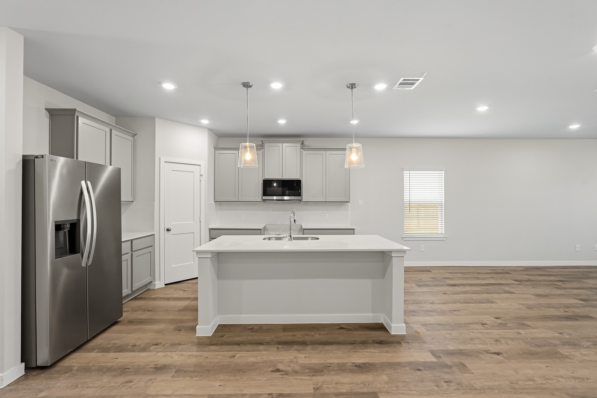 A kitchen with white cabinets.