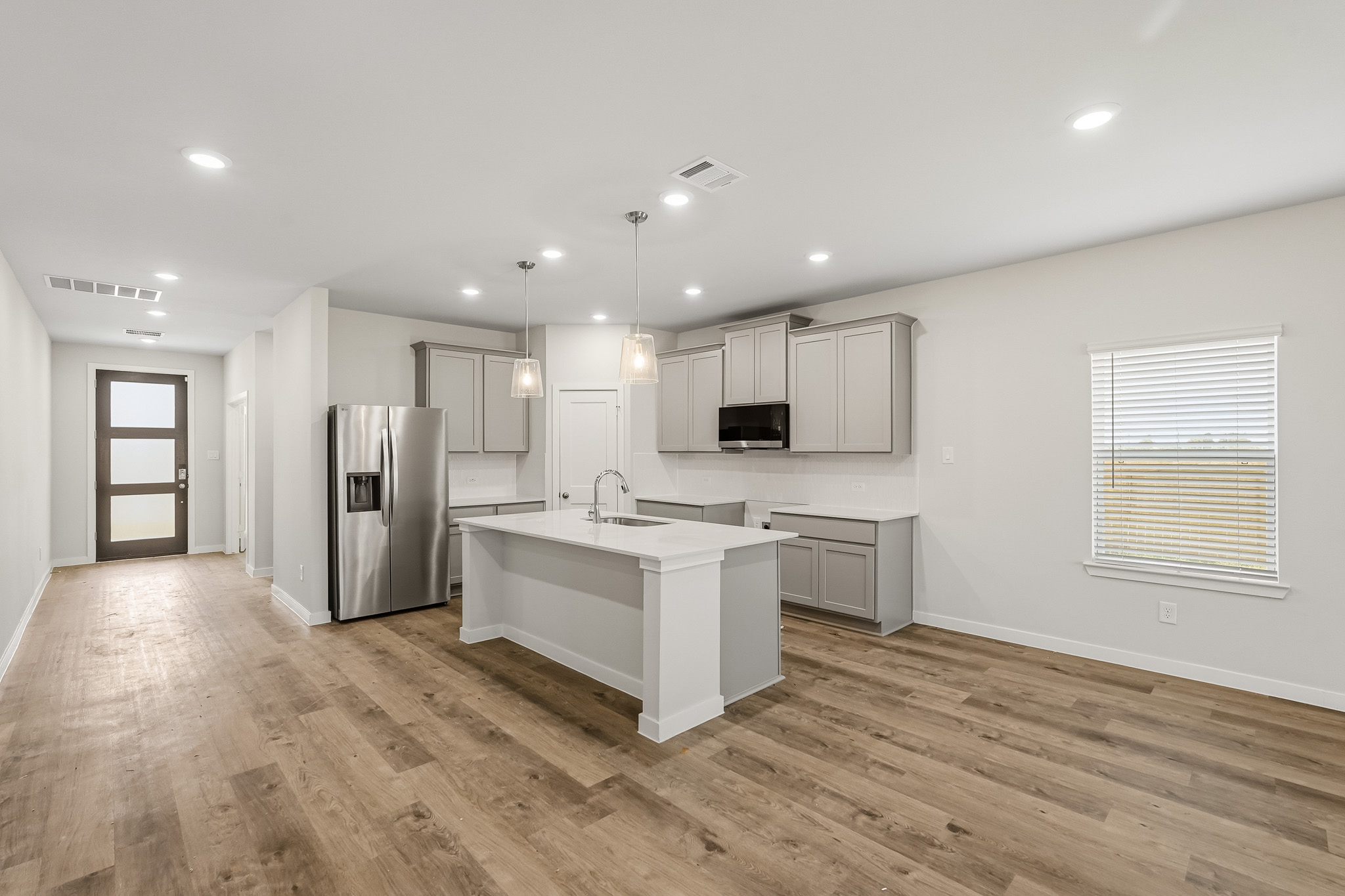 A kitchen with white cabinets.