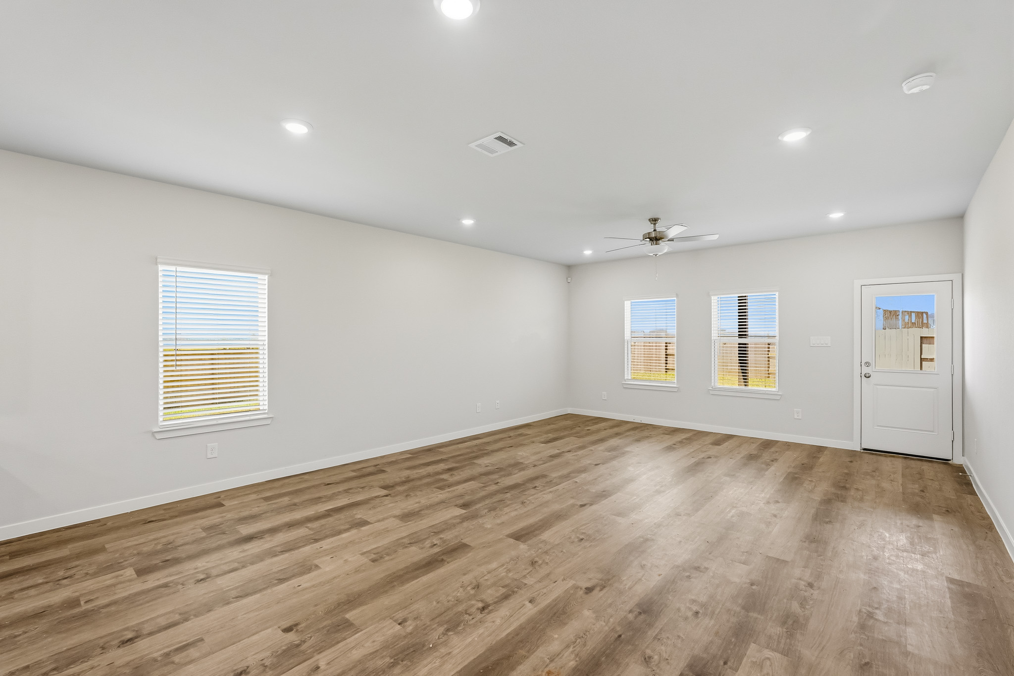 A room with a wood floor and white walls.