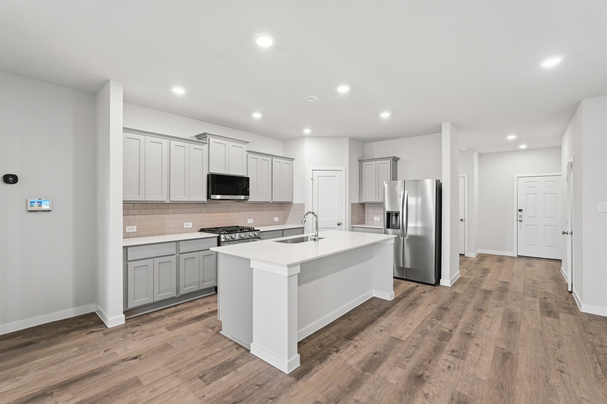 A kitchen with white cabinets.