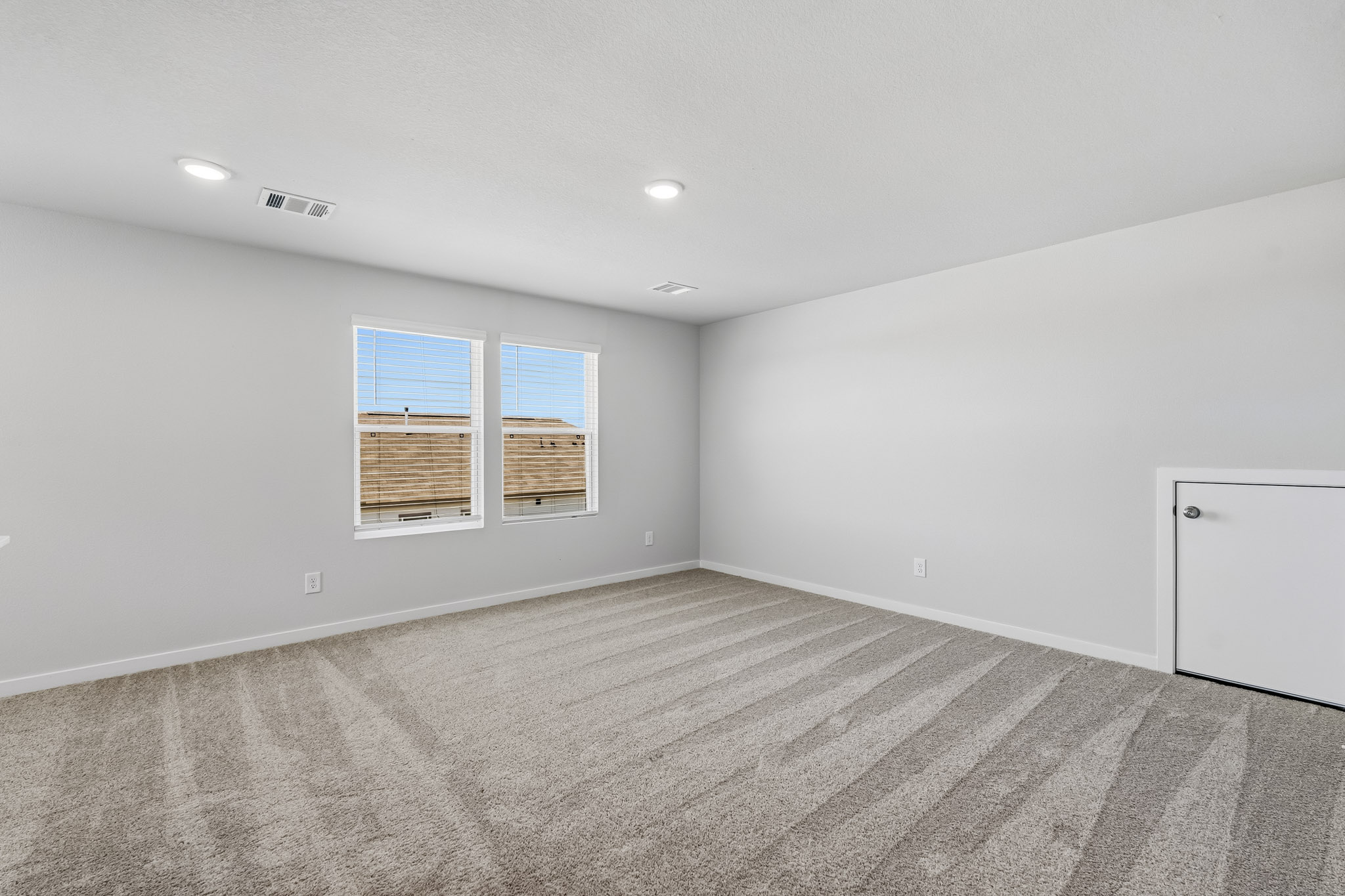 A room with a window and a door.