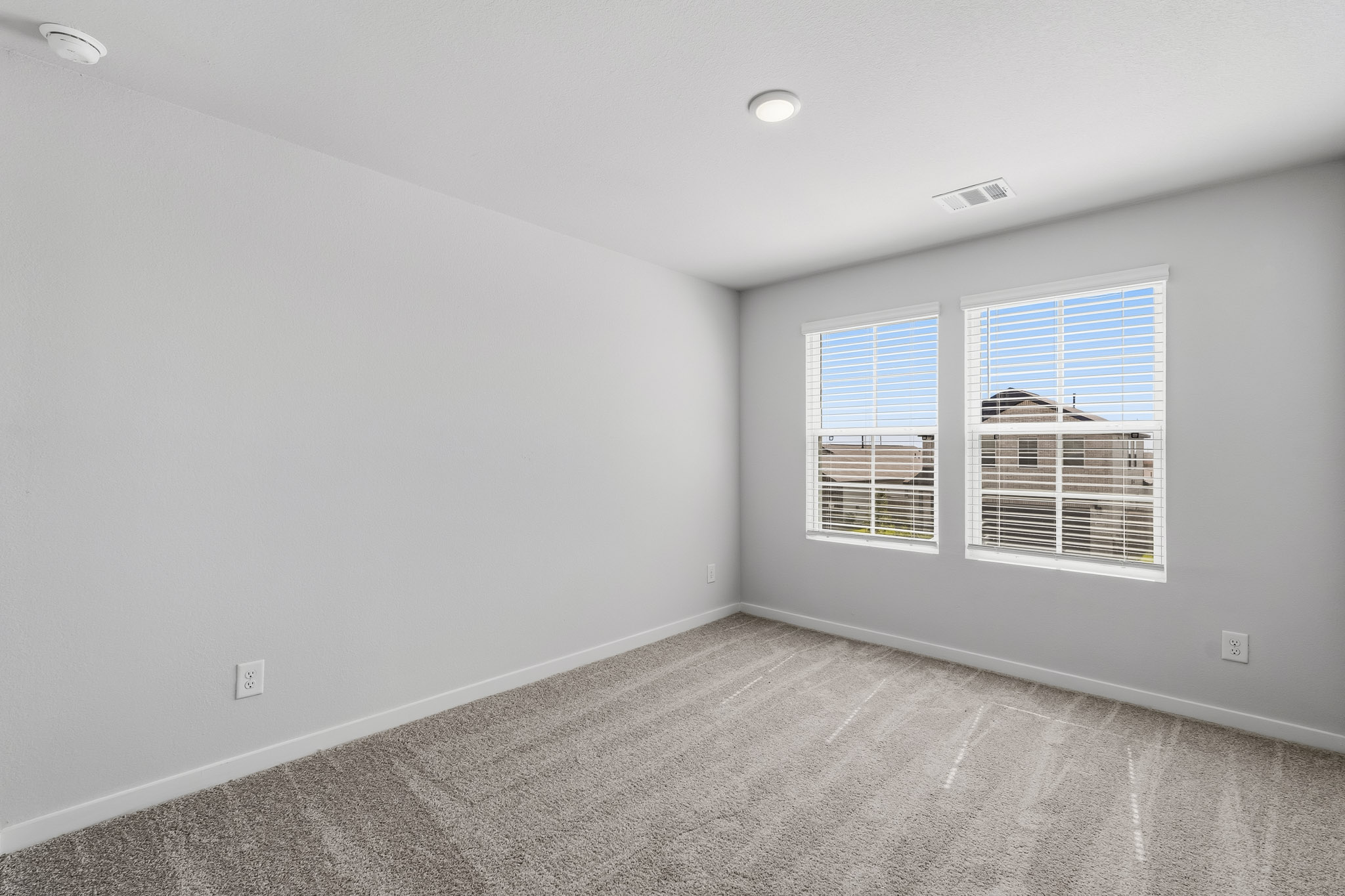 A room with a window and a carpet.