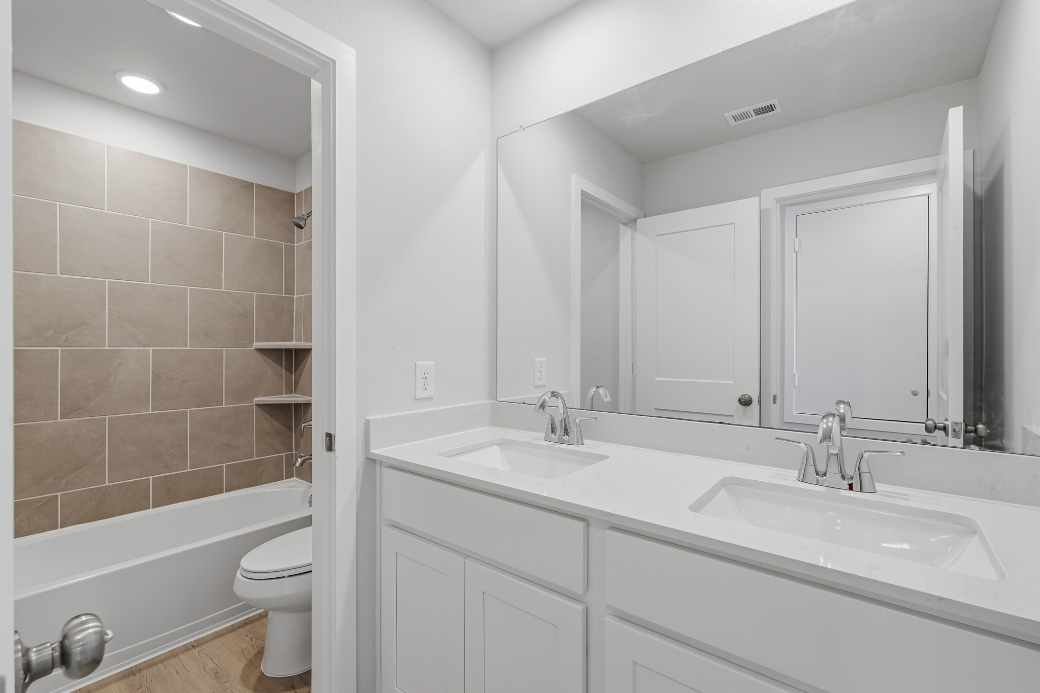 A bathroom with a tub sink and toilet.