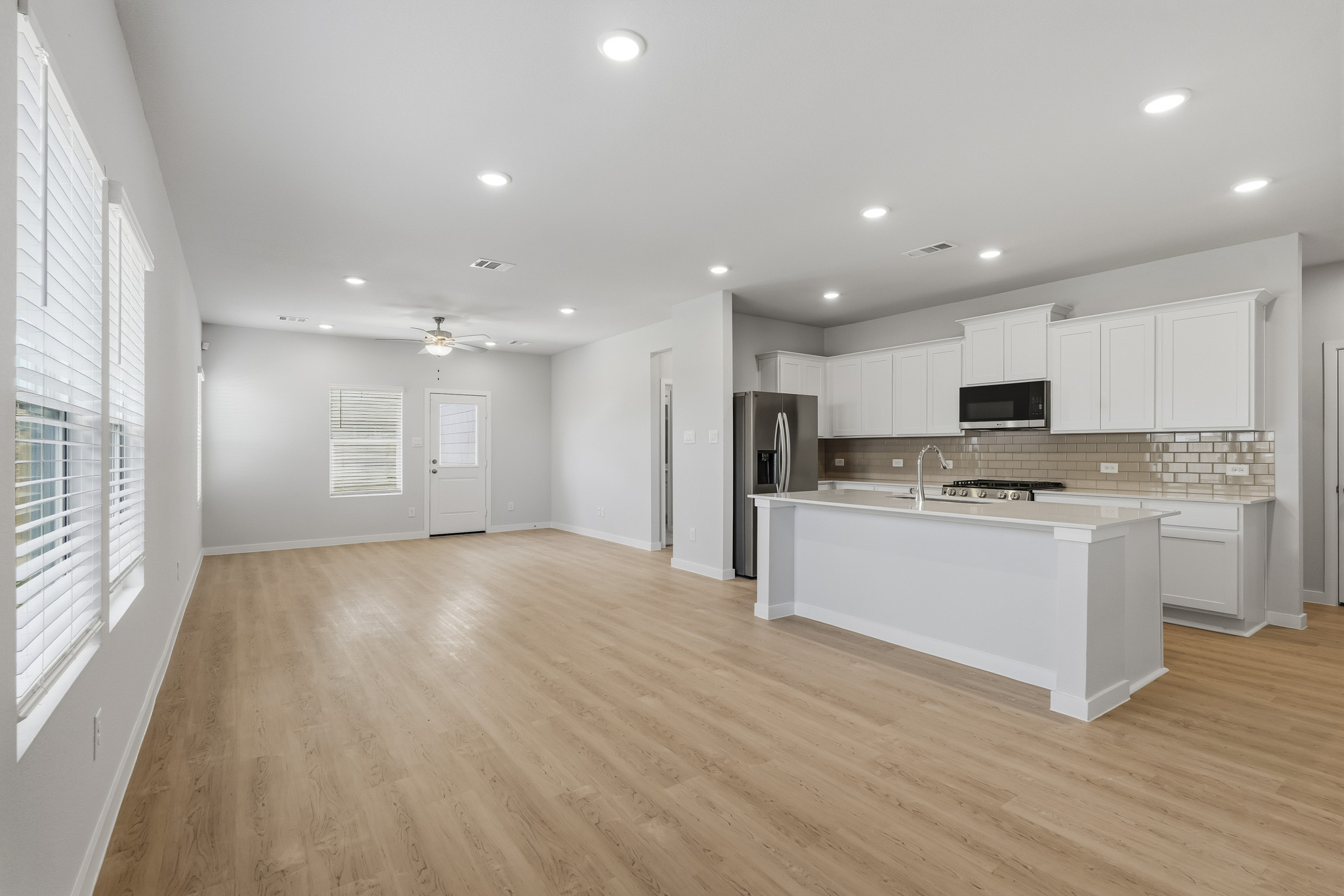 A kitchen with white cabinets.