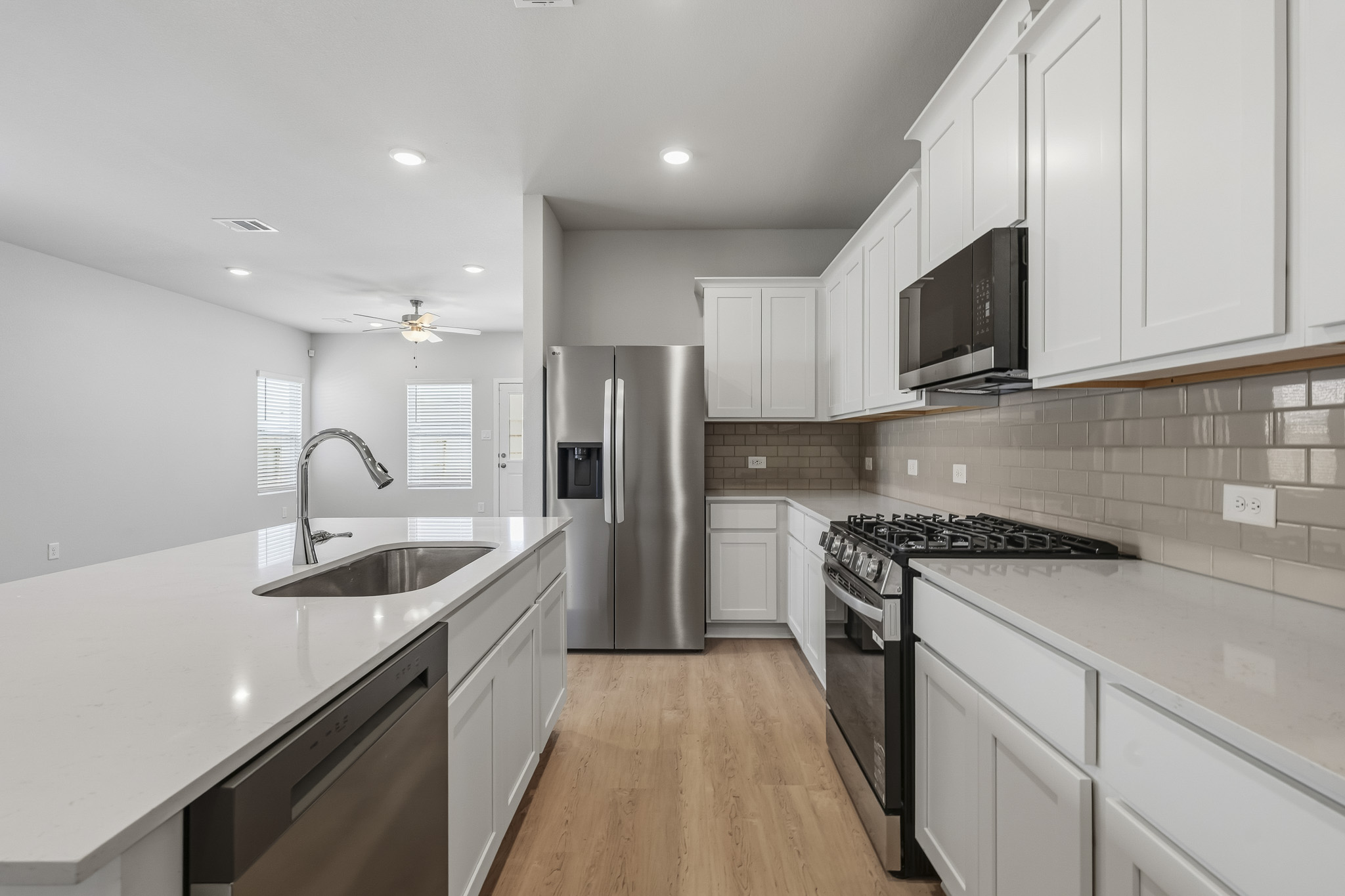 A kitchen with white cabinets.