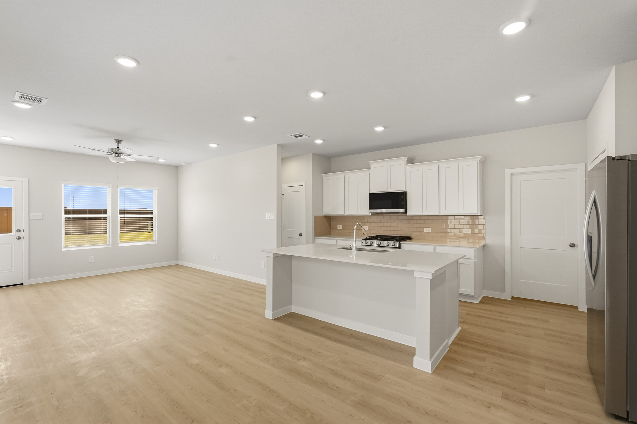 A kitchen with white cabinets.