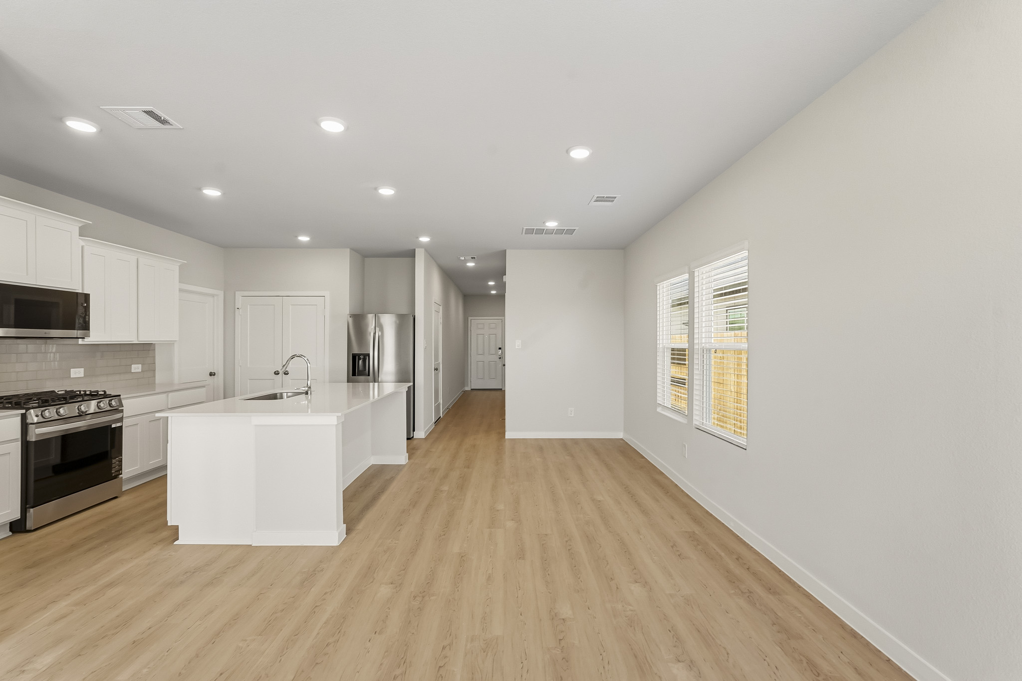 A kitchen with white cabinets.
