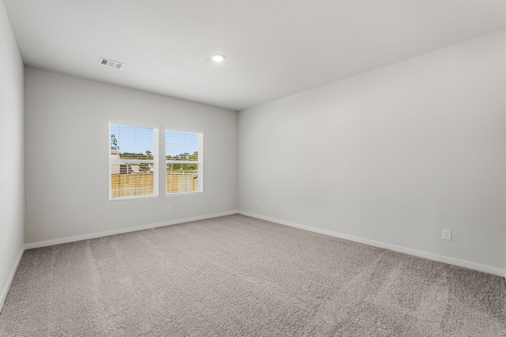 A room with a window and a carpet.