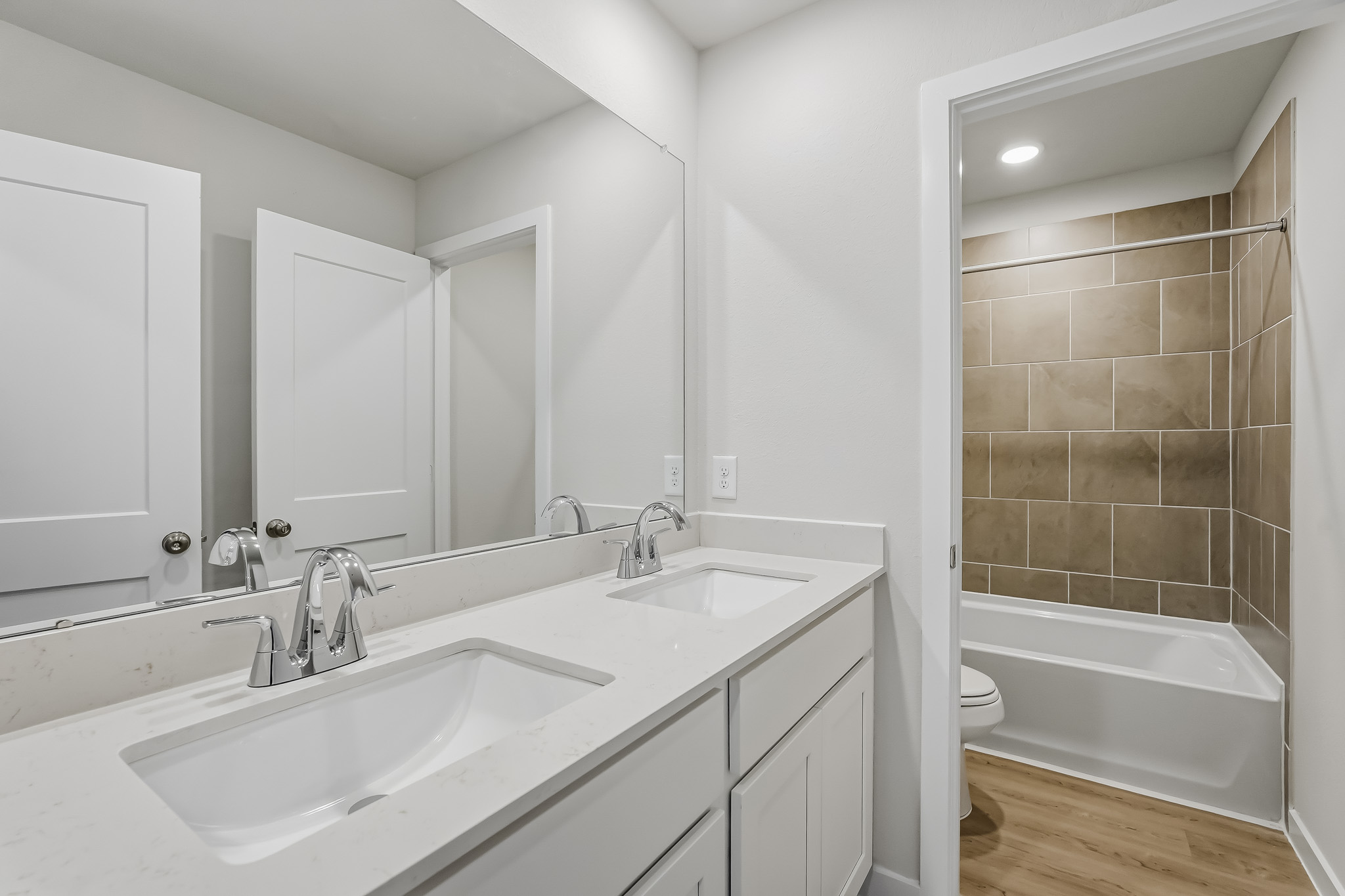 A bathroom with a tub sink and toilet.