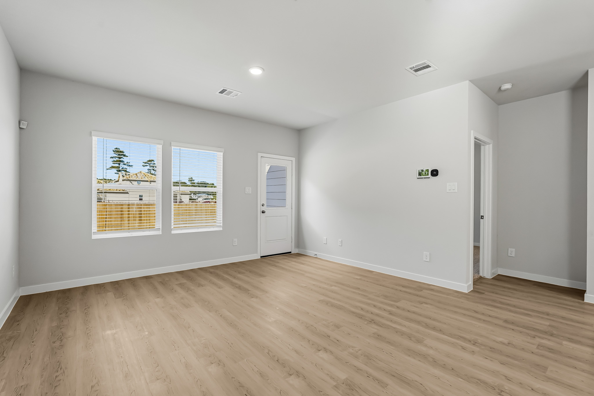 A room with a wood floor and white doors.